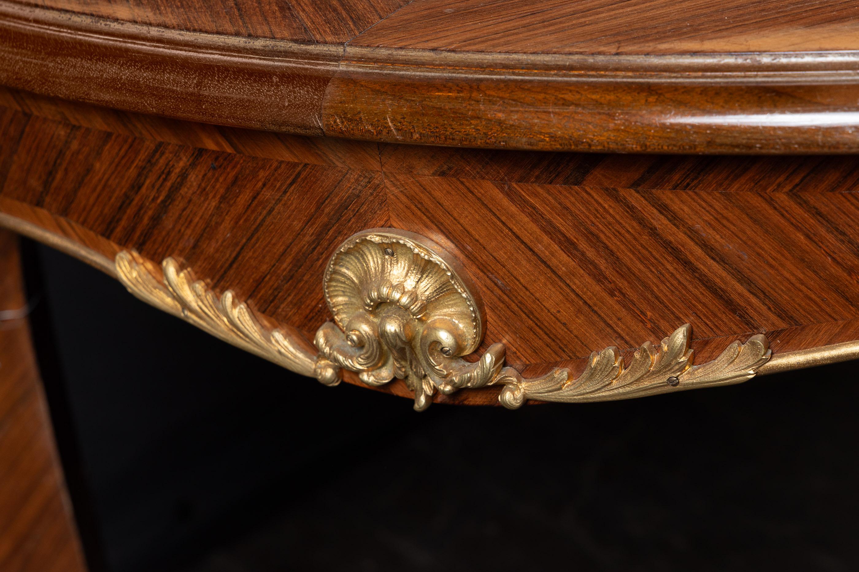 Beautiful French 19th century marquetry dining table. The piece is a fine example of the Louis XV style. It sports detailed bronze d'ore mounts and one matching marquetry leaf. The piece features its original top which will need to be refinished. If