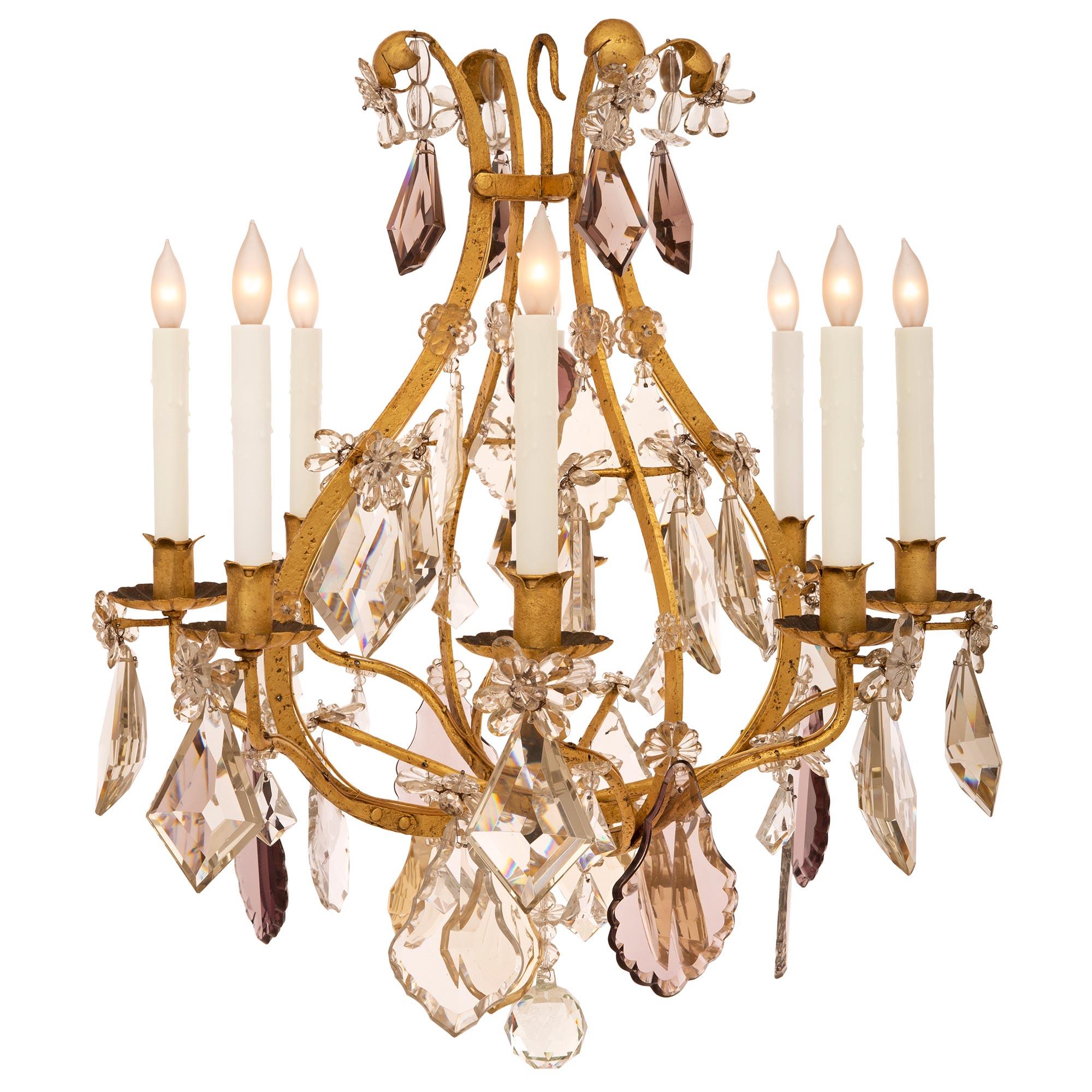 A lovely French 19th century Louis XV st. gilt metal and Baccarat crystal chandelier by Maison Bagues. The chandelier is centered by a beautiful cut crystal ball amidst a superb array of clear, smoked and amethyst colored cut crystal pendants