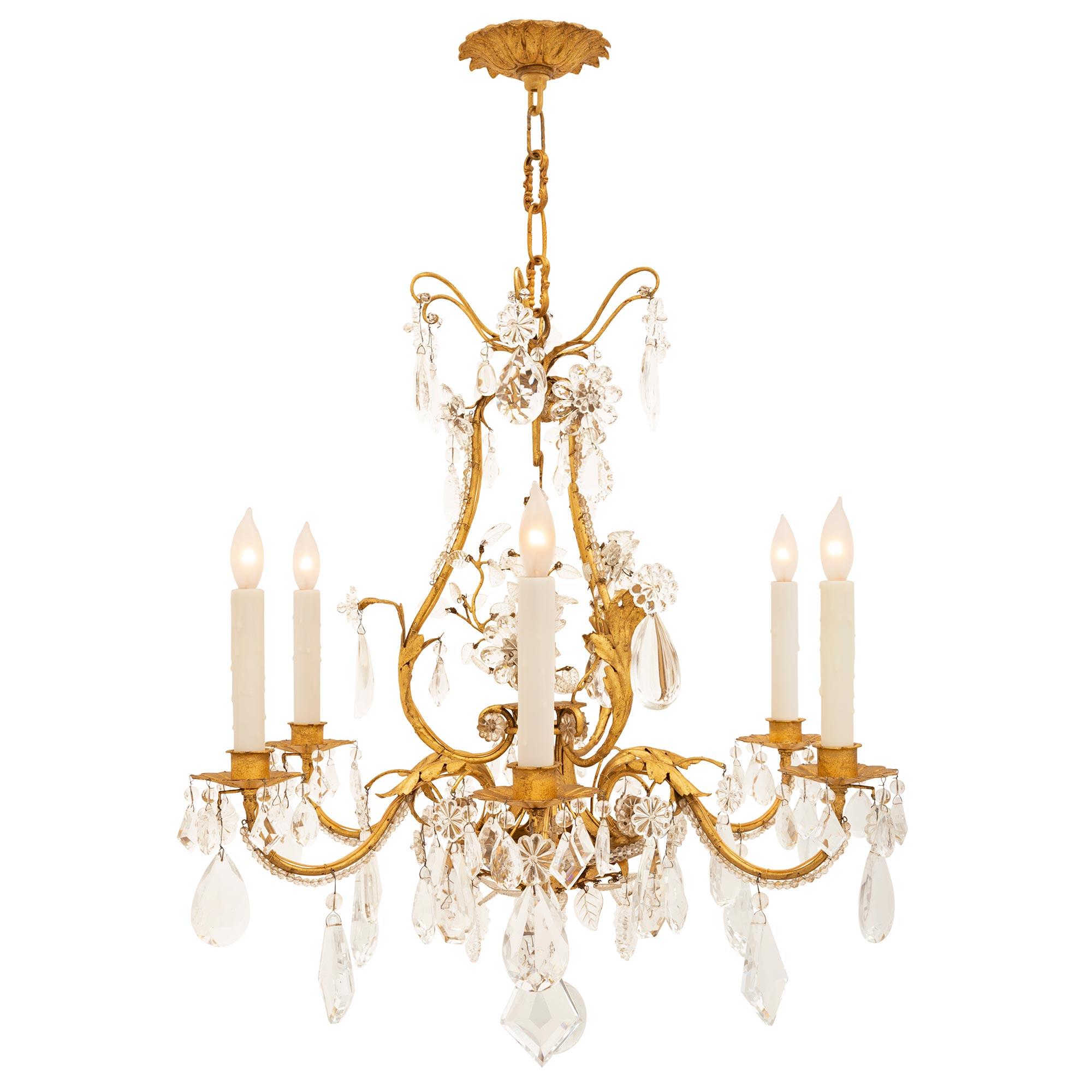 An outstanding French 19th century Louis XV st. gilt metal and crystal chandelier attributed to Maison Bagues. The six arm chandelier is centered by a beautiful solid crystal bottom ball below superb gilt metal acanthus leaves amidst a stunning