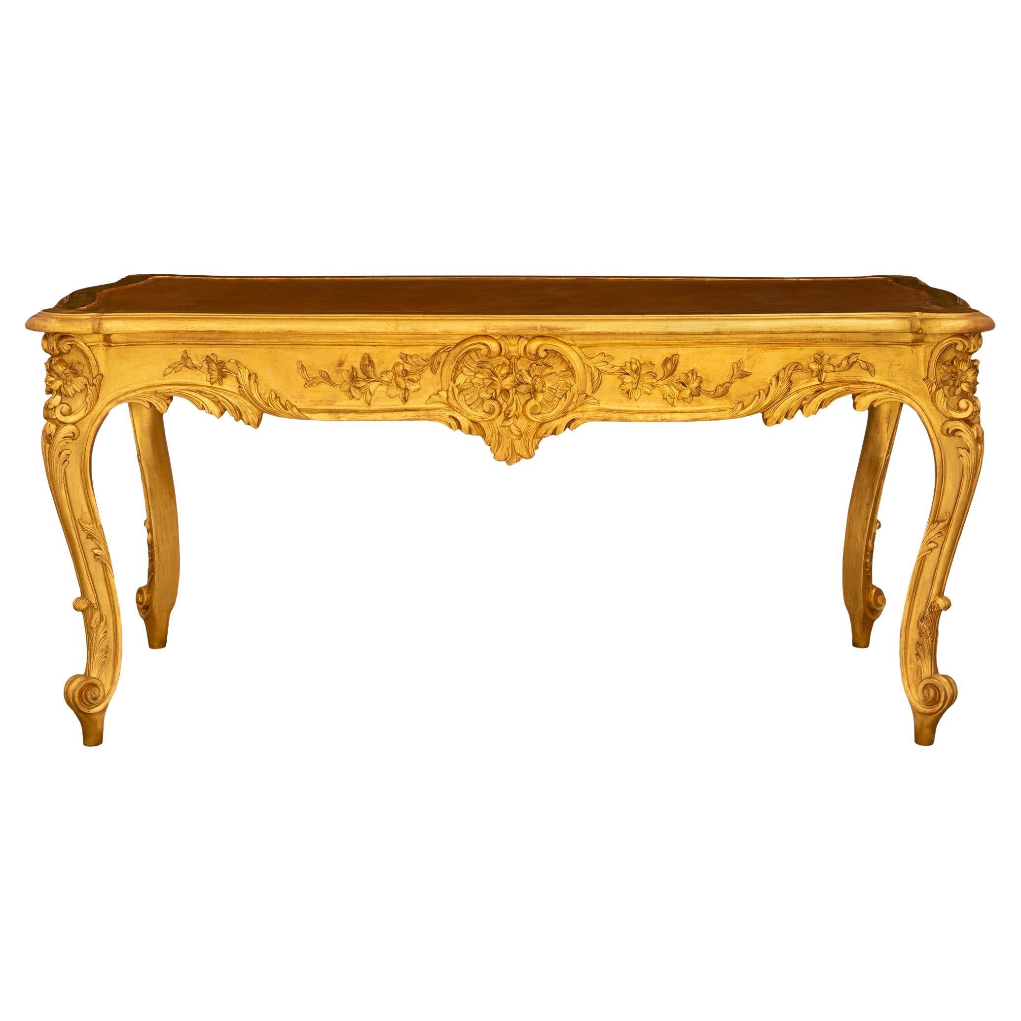 French 19th century Louis XV st. Giltwood and leather center table/desk