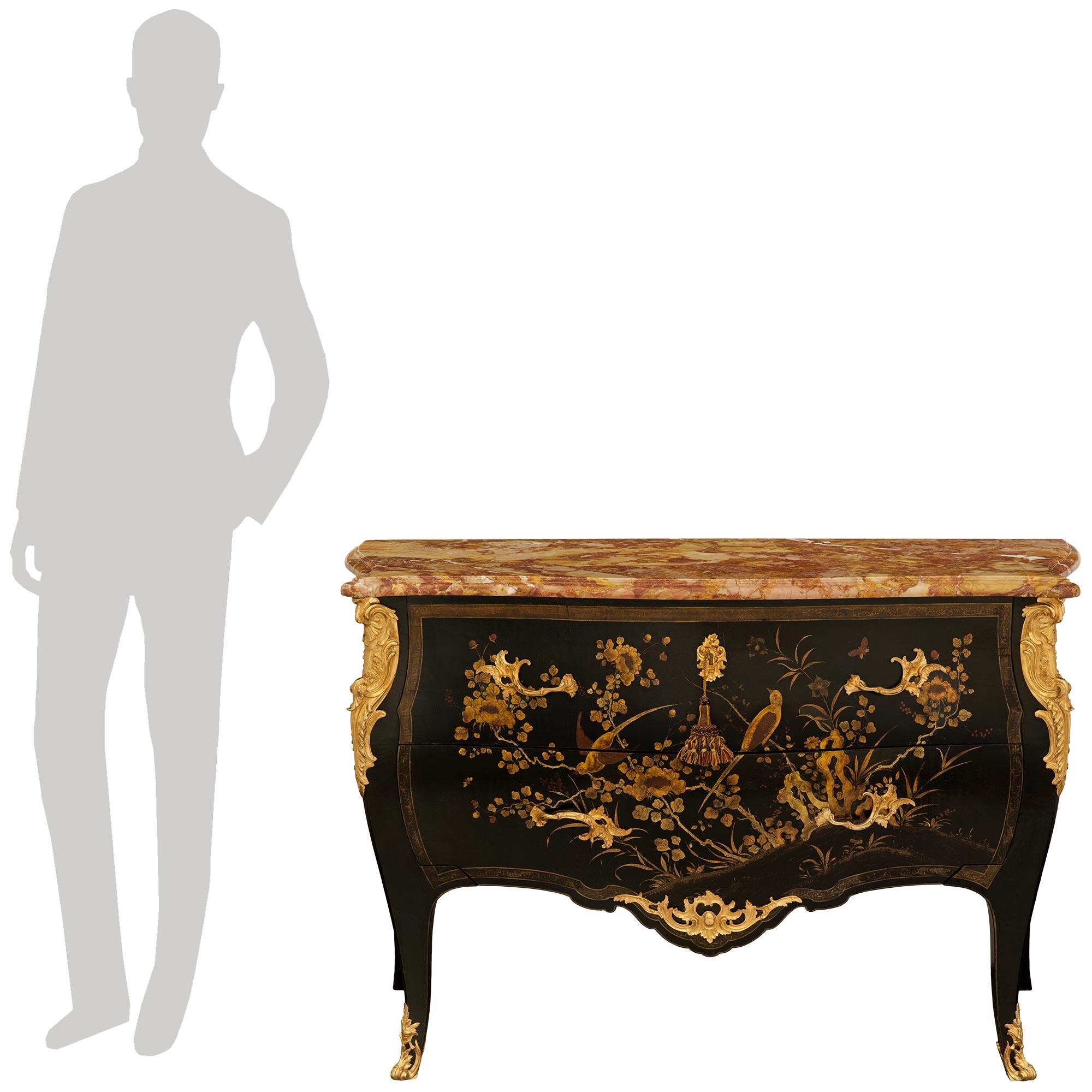 A most decorative and high quality French 19th century Louis XV st. Japanese Lacquer, Ormolu and Marble commode. The stunning two drawer commode is raised by cabriole legs ending with elegant pierced Ormolu sabots and top Ormolu mounts of scrolled