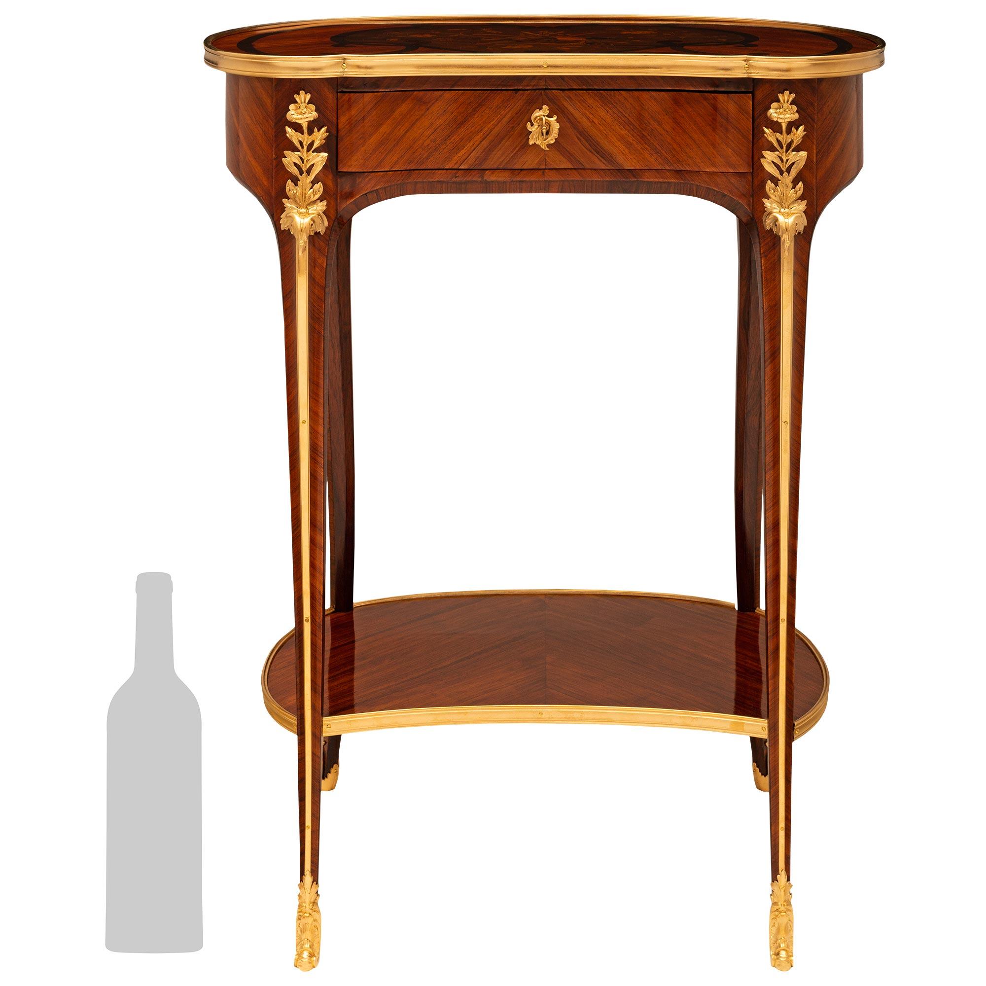 A beautiful and high quality French 19th century Louis XV st. Kingwood, Tulipwood, and Ormolu side table. This wonderful kidney shaped freestanding side table is raised on four finely tapered square cabriole legs with foliate decorated sabots. The