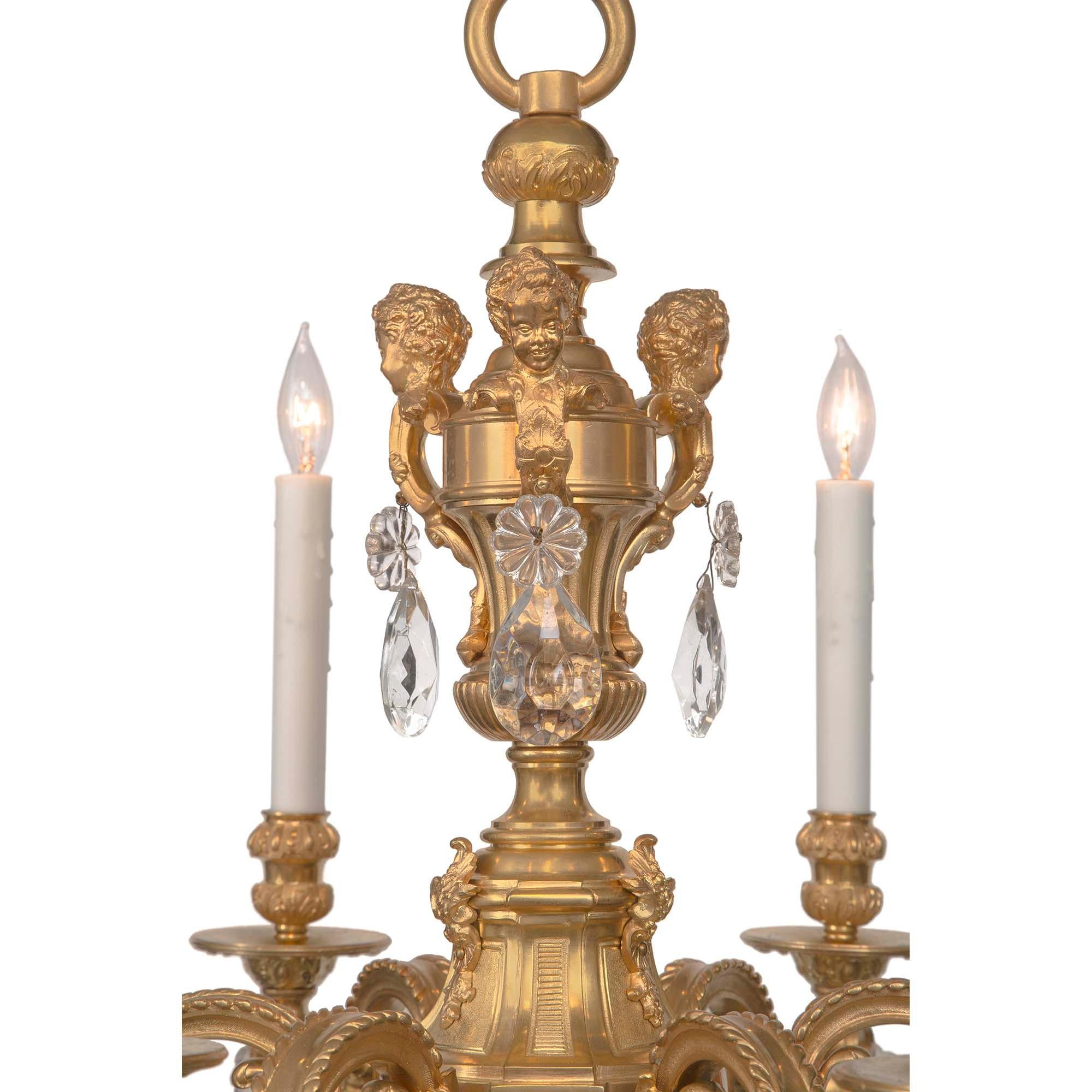 A most elegant French 19th century Louis XV st. ormolu and Baccarat crystal six arm chandelier. The chandelier is centered by a richly chased ormolu acorn finial below most decorative foliate patterns in a fine satin and burnished finish. Each