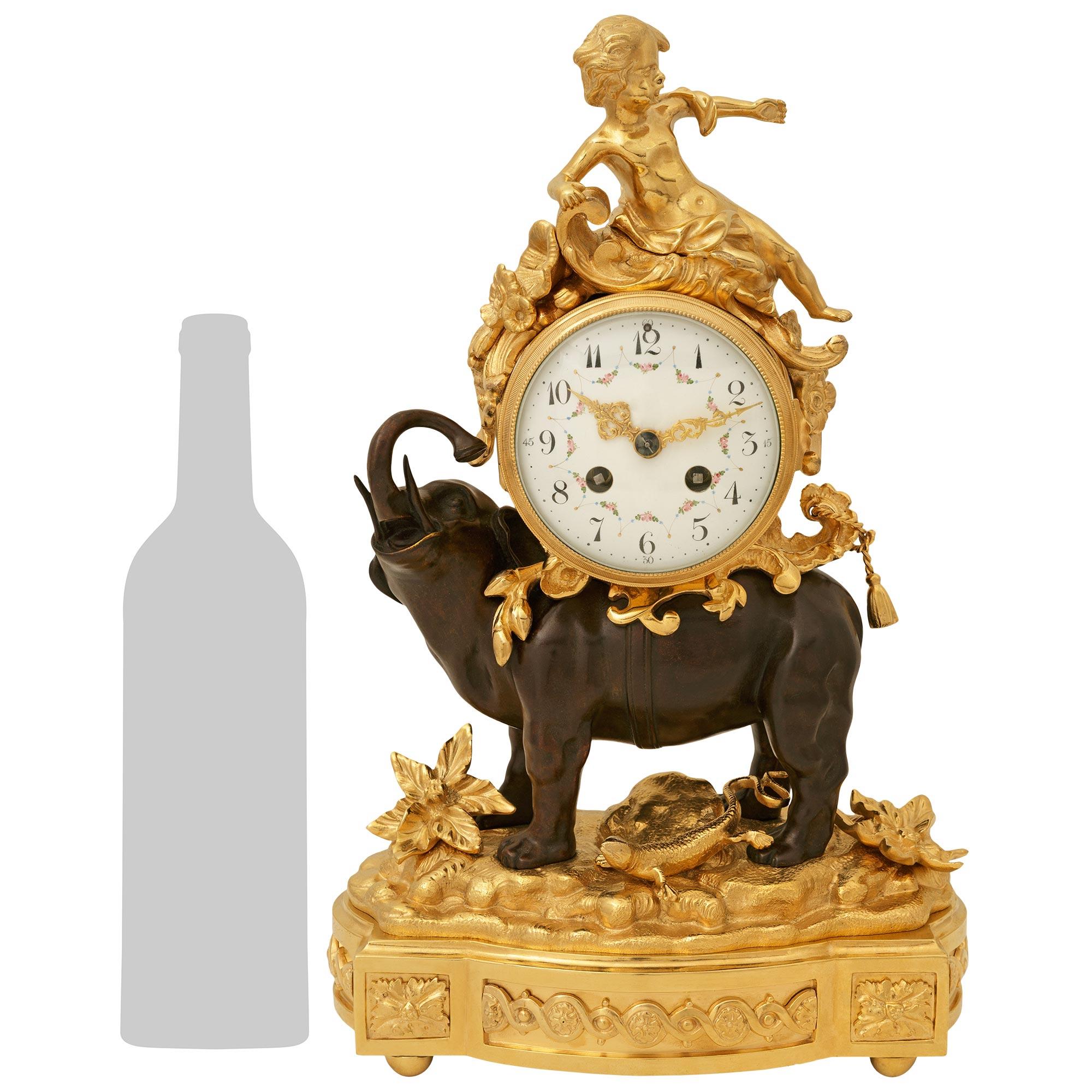 A charming and high quality French 19th century Louis XV st. Ormolu and patinated Bronze clock. This most decorative mantel clock is raised on Ormolu base with a bombee front displaying an intertwined circular design flanked by rosettes at the