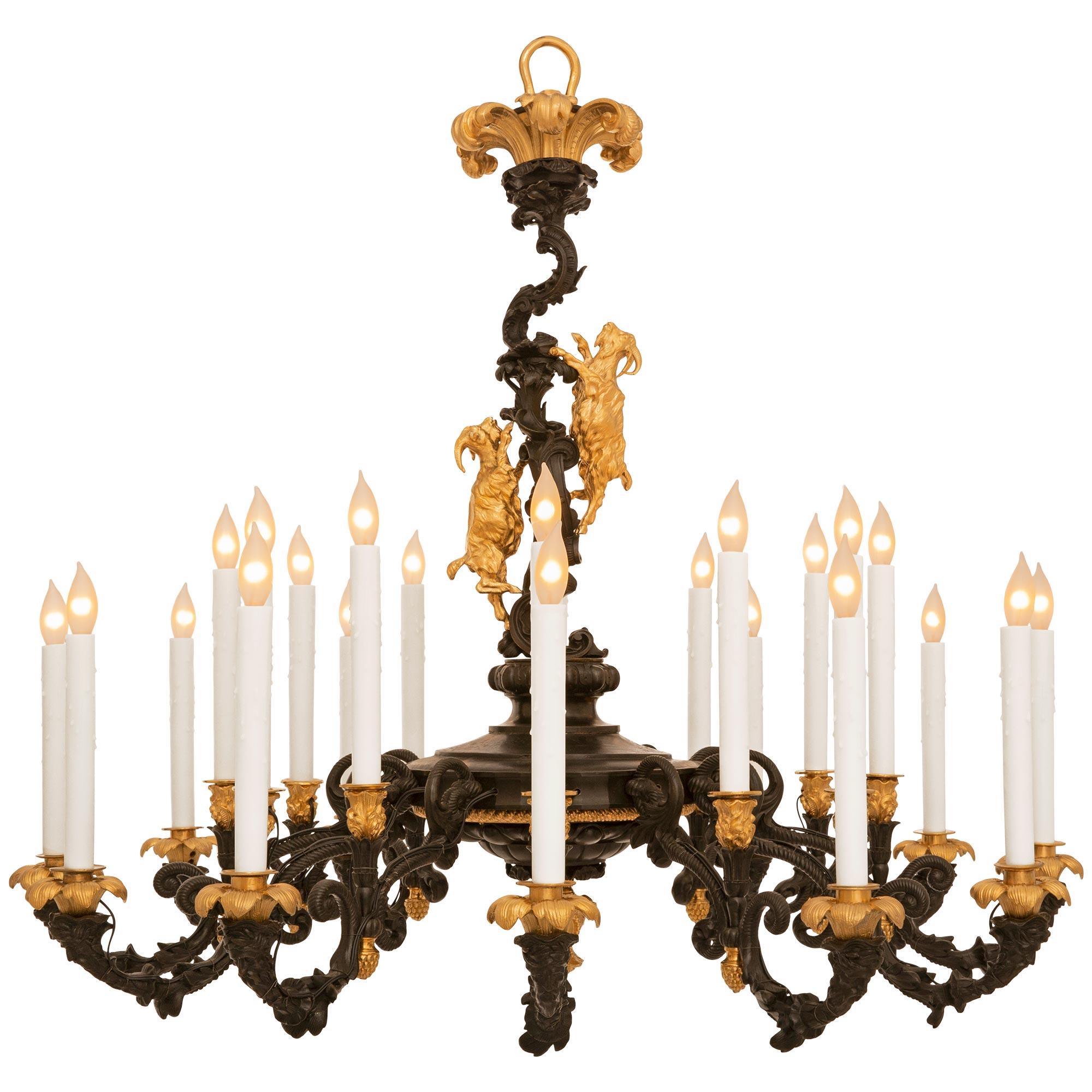 A stunning and most decorative French 19th century Louis XV st. patinated Bronze and Ormolu chandelier. This exquisite twelve arm twenty four light chandelier is centered around an Ormolu berried foliate bottom finial. Above the bottom finial is a