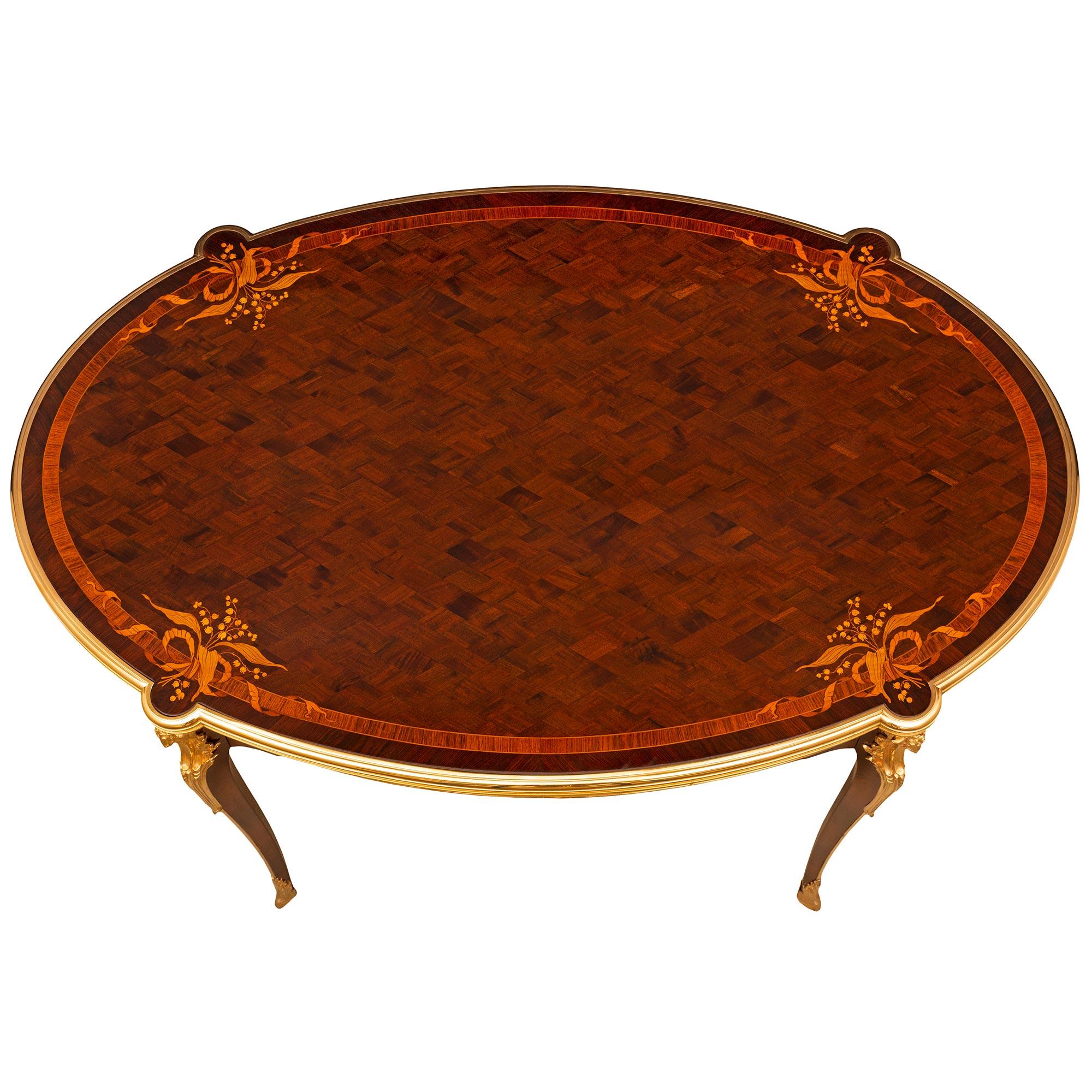 A stunning and extremely high quality French 19th century Louis XV st. Mahogany, Kingwood and ormolu side table/desk signed Krieger. The oval table is raised by elegant cabriole legs with fitted ormolu hoof, acanthus leaf sabots, and displaying a