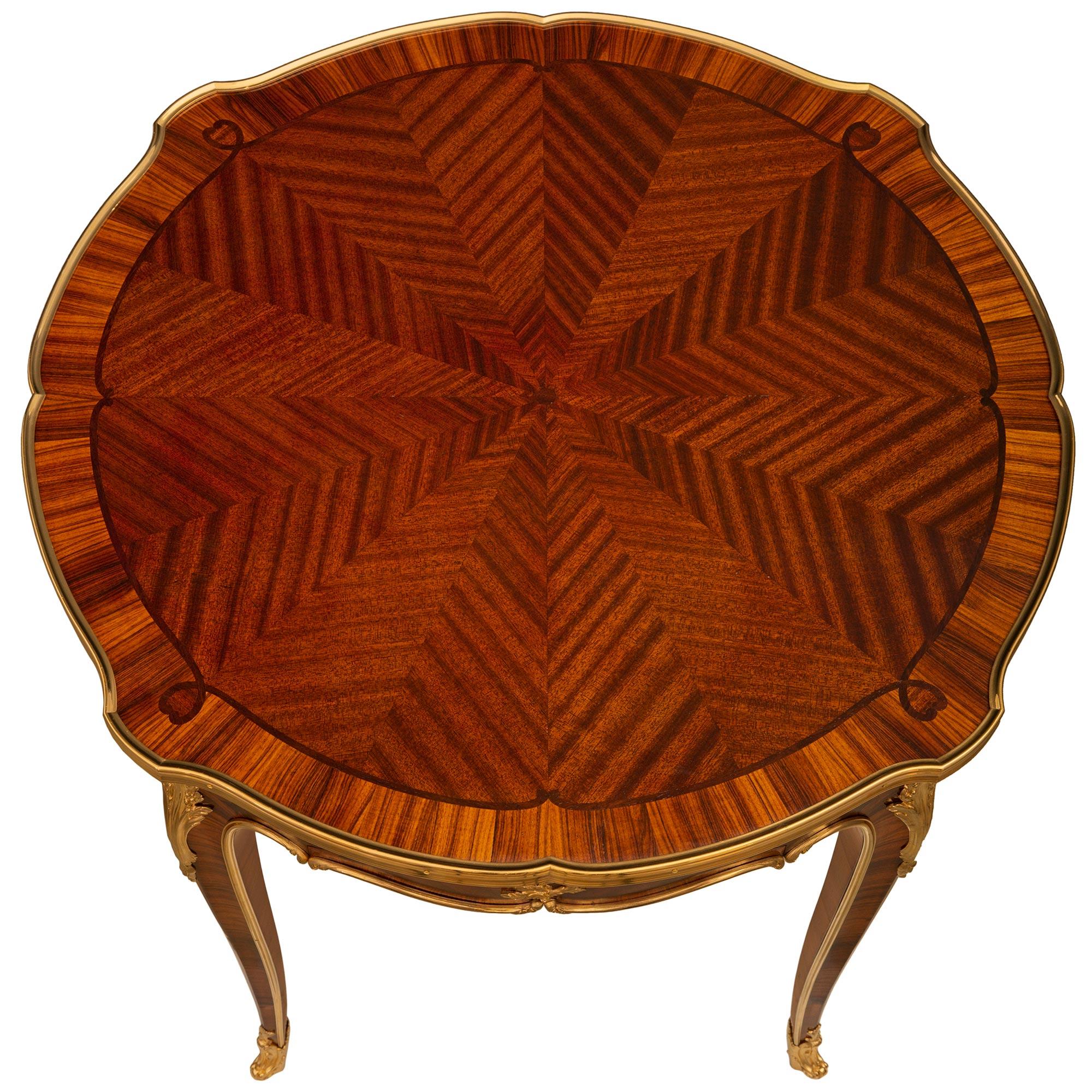 A beautiful French 19th century Louis XV st. Tulipwood, Kingwood and Ormolu side table, signed Krieger, Paris. This wonderful piece is raised on four square tapered slender legs with wrap around Ormolu sabots. The outer edge of each leg has a
