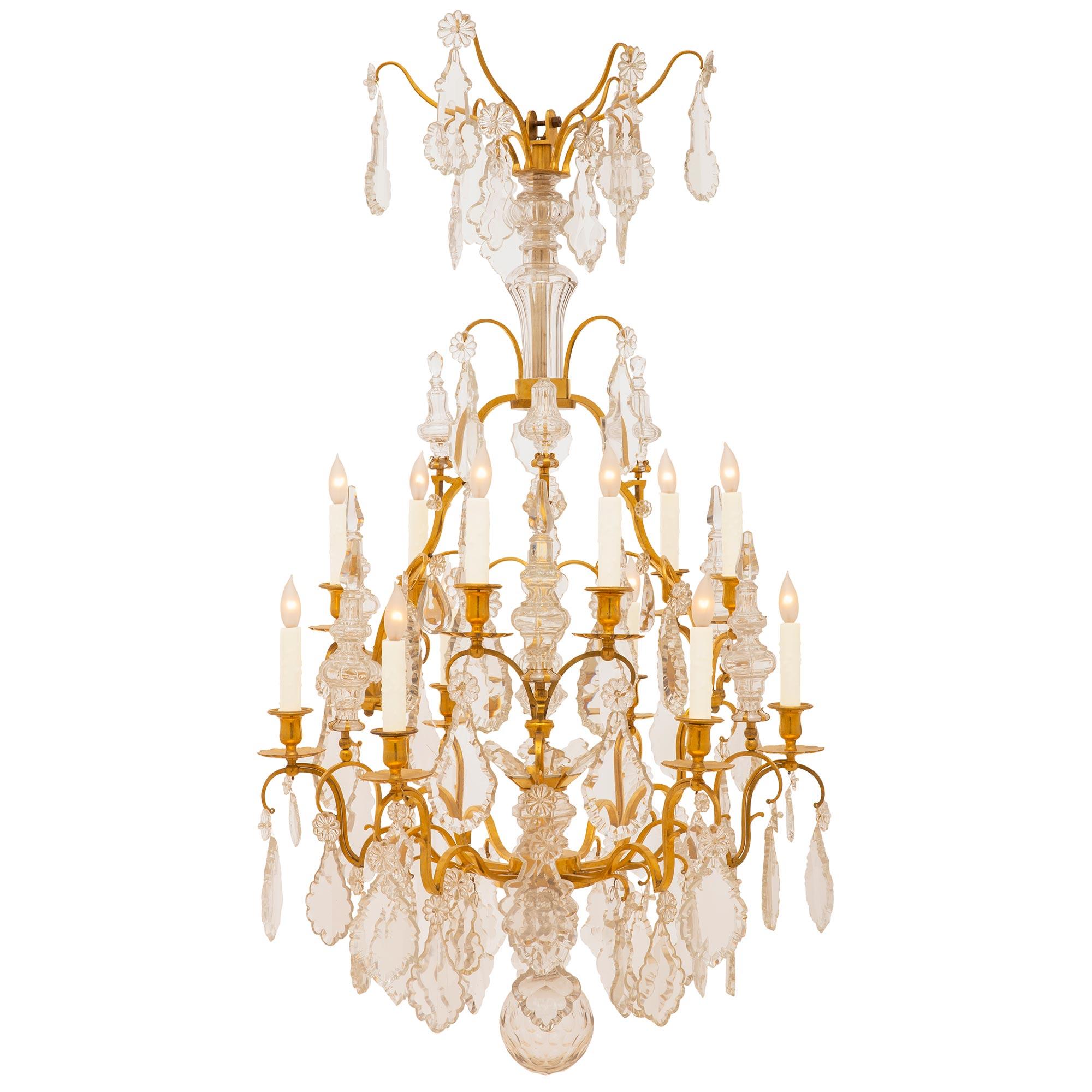 A high quality French 19th century Louis XV st. ormolu and Baccarat crystal chandelier. The twelve light chandelier has impressive scrolling ormolu arms decorated by elegant and finely cut crystals throughout. Each arm ends with an ormolu bobeche or