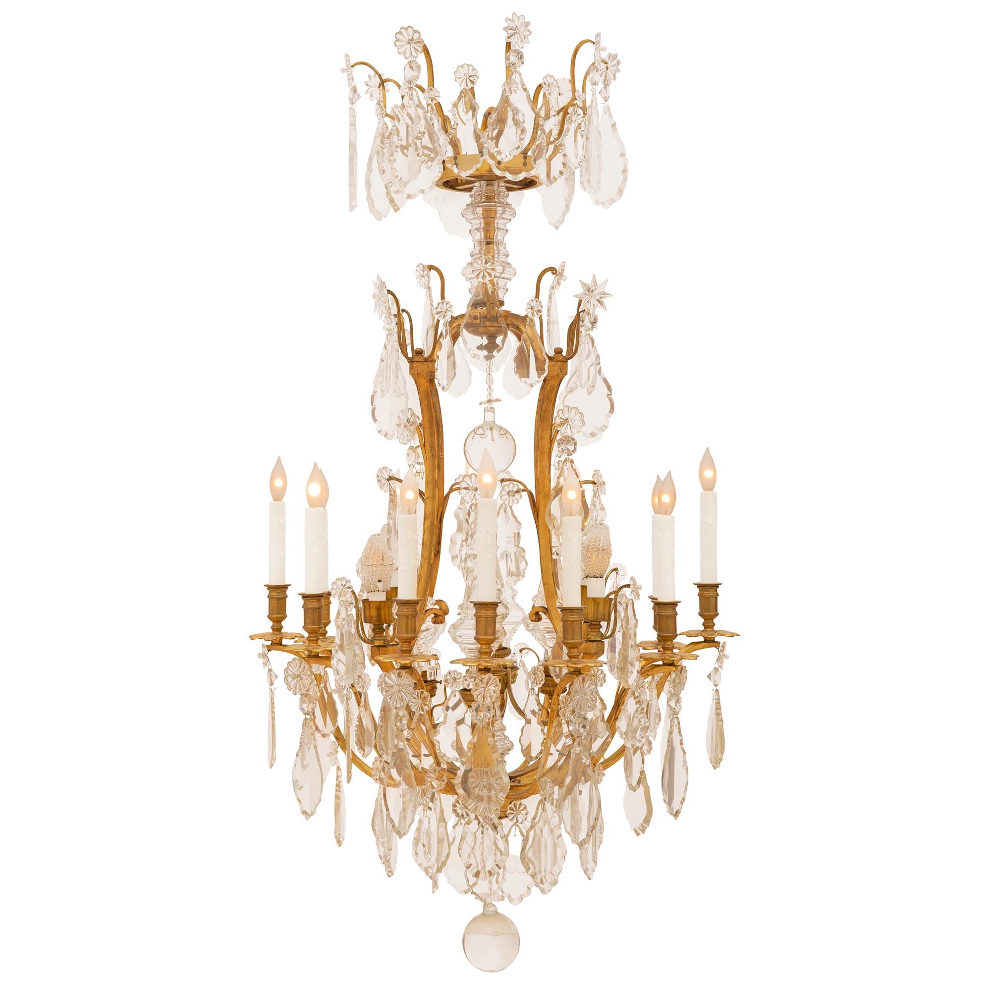 A most impressive and large scale French Louis XV st. 19th century circa. 1870, ormolu and Baccarat crystal chandelier. With 12 electrified arms and a total of 17 lights and an extensive amount of exceptional crystals hanging on 'S' scrolled arms