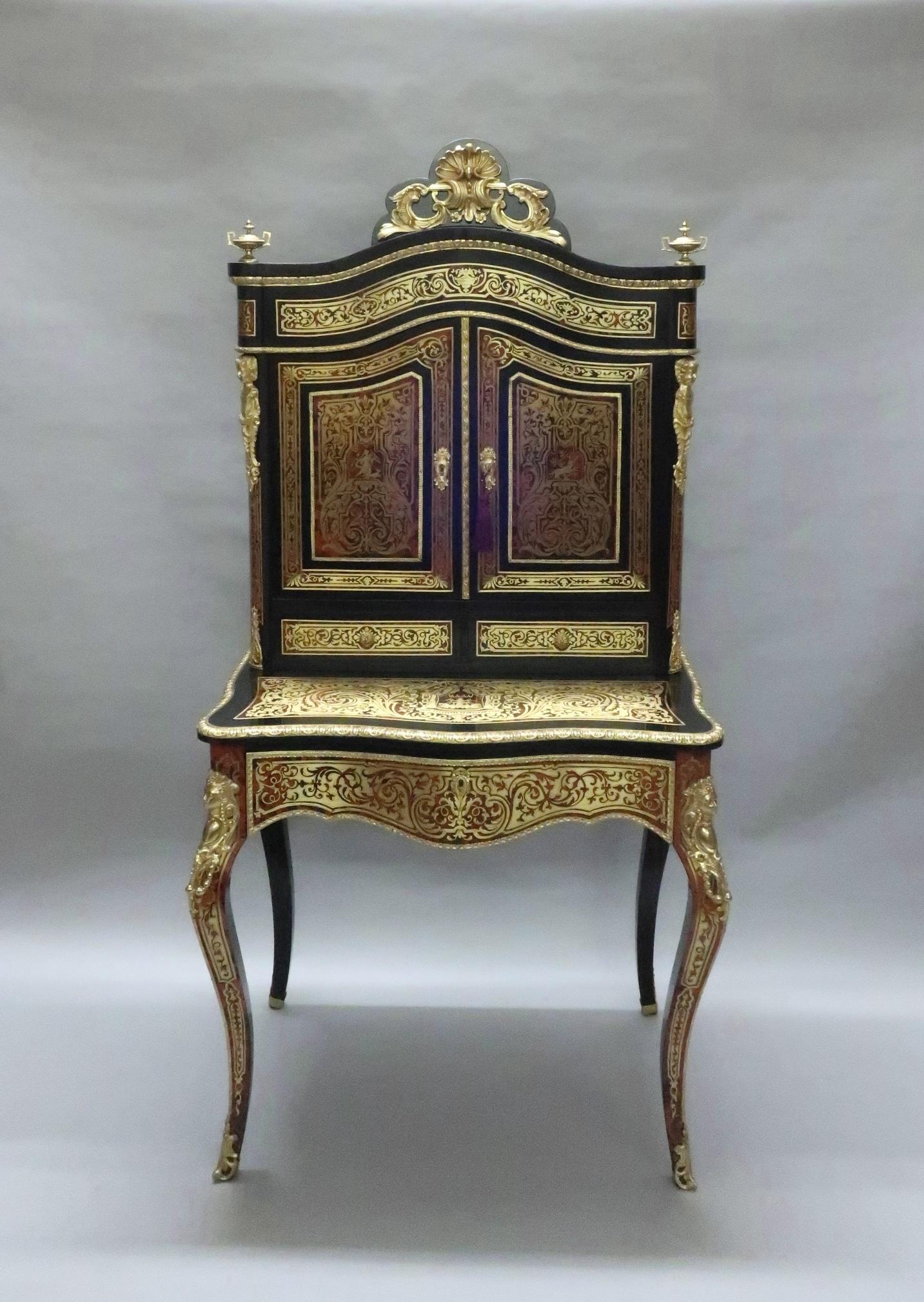 An exceptional French serpentine shaped boulle red tortoiseshell and engraved brass Bonheur du jour. At some time in its life it has been adapted into a very fine looking dressing table. The base on the cabinet has a drawer to the front which opens
