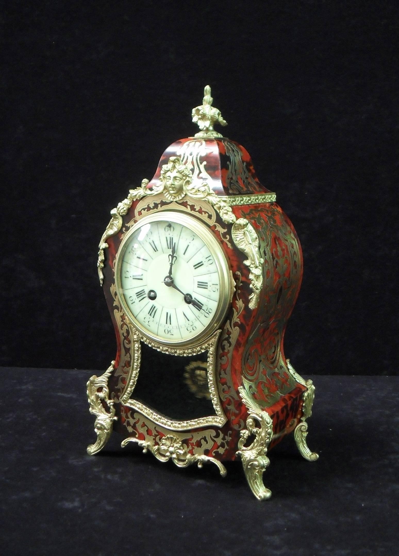 A good quality French Louis XV style Boulle brass and red tortoise shell inlaid mantel clock with ormolu mounts and enamel dial. The clock has a French eight day movement which strikes the hours and half hours on a gong.

The movement is stamped