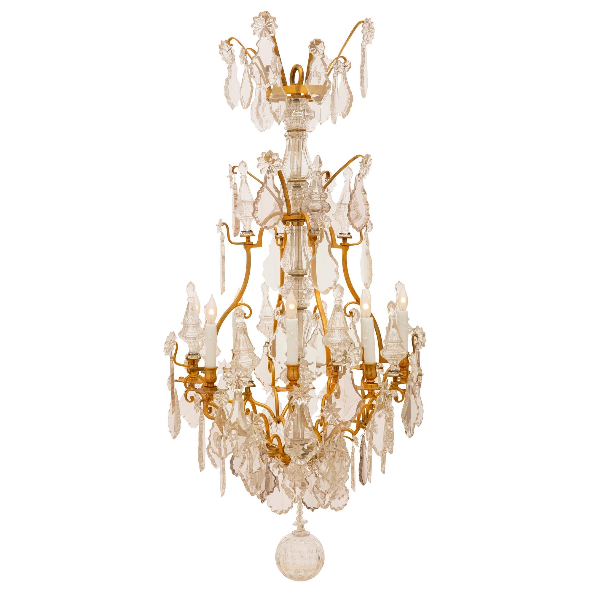 A stunning and important French early 19th century Louis XV st. Baccarat crystal and ormolu eight light chandelier. The incredible Baccarat central fut is surrounded by scrolled ormolu arms decorated by two rows of daggers, amidst different size and