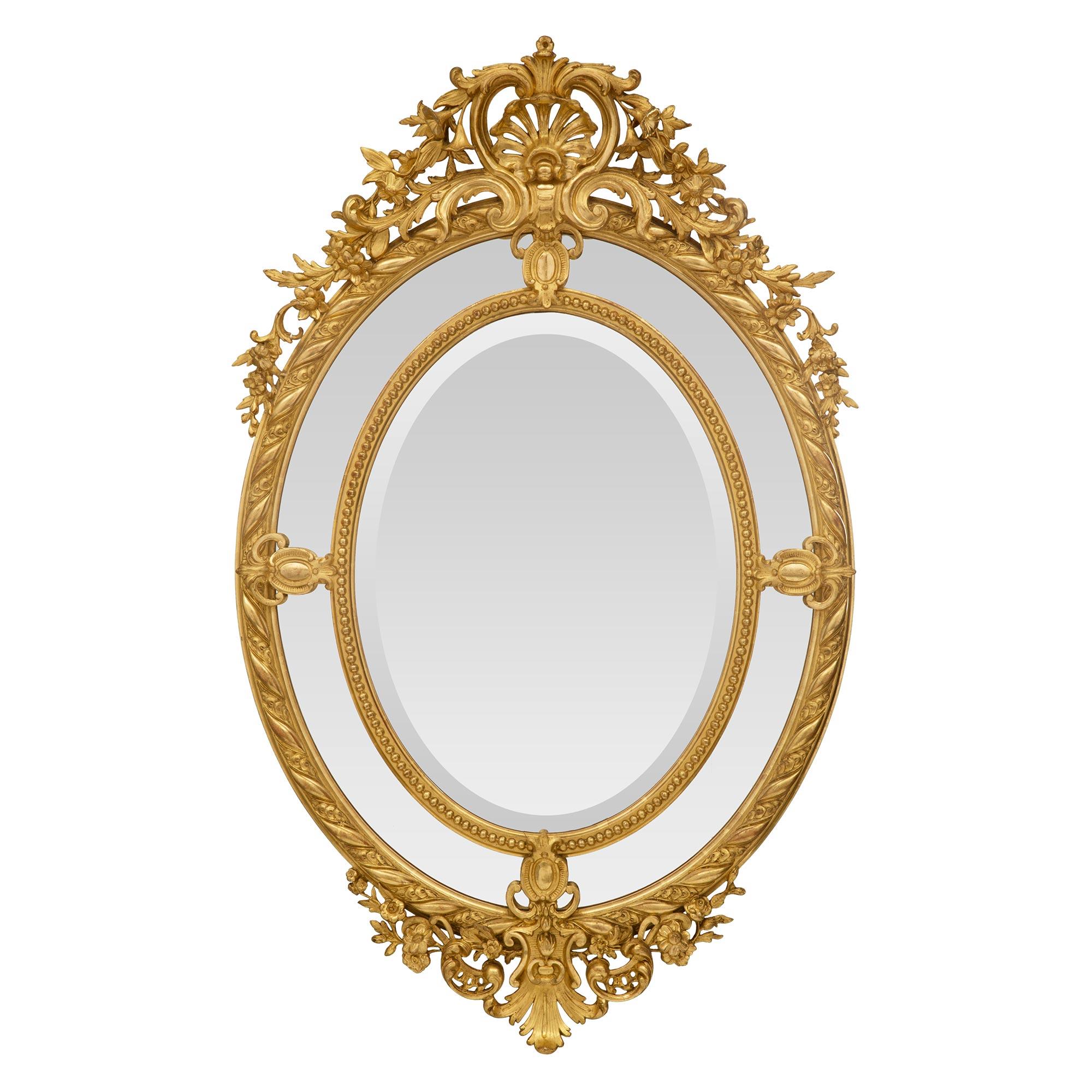 Miroir ovale en bois doré à double cadre de style Louis XV du 19ème siècle français