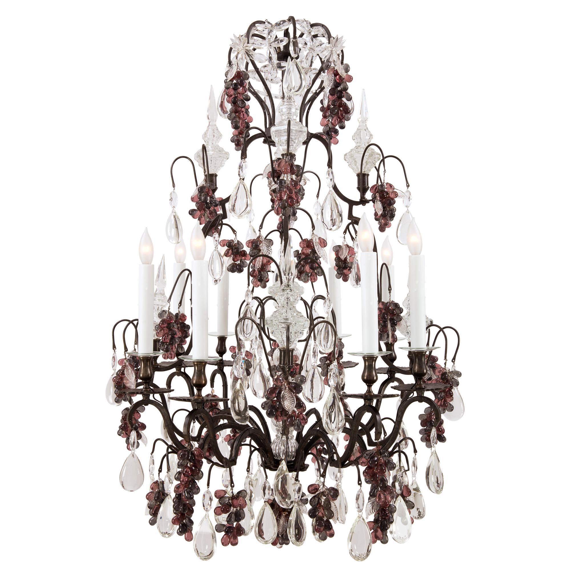 A beautiful French 19th century Louis XV st. wrought iron, crystal and colored glass eight light chandelier. The chandelier is centered by striking and wonderfully executed grape clusters of lovely colorful glass beads and exceptional etched crystal
