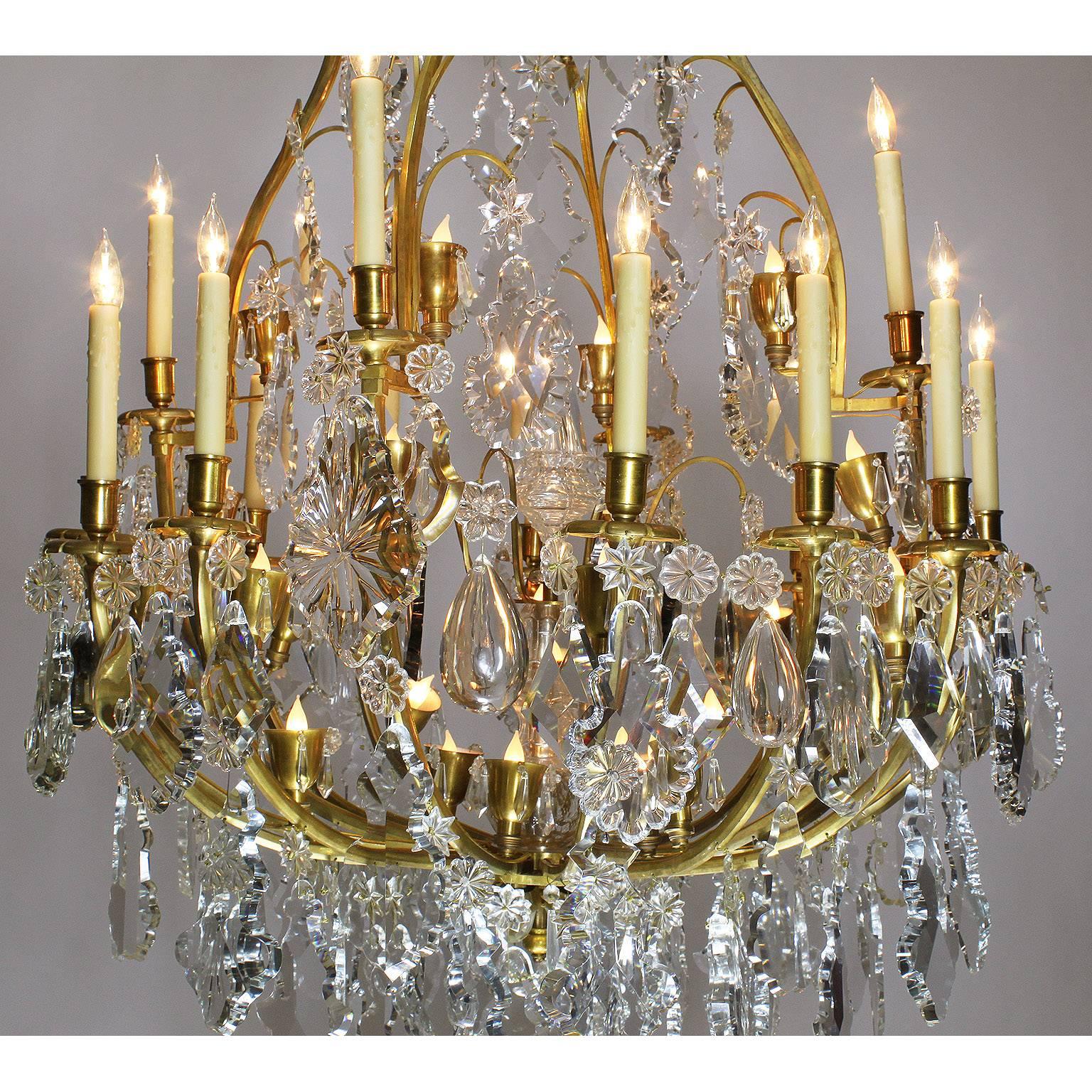 A palatial French 19th century Louis XV style gilt bronze and cut-glass 16 candle-arms and 28 Interior light chandelier, attributed to Baccarat. The elongated gilt bronze frame with 16 scrolled candle arms (now electrified) and 28 brass cups lights