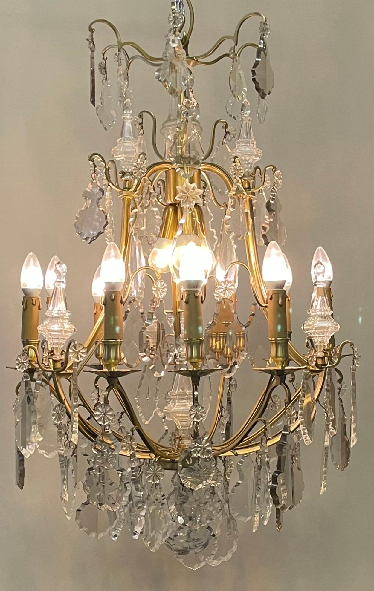 A wonderful high quality Louis XV gilt bronze and cut- crystal chandelier, France, 1840-1880s.
This beautiful chandelier is made of gilt bronze suspended with big crystal prism in three different colors ( amethyst, smoke and clear).
Fully restored