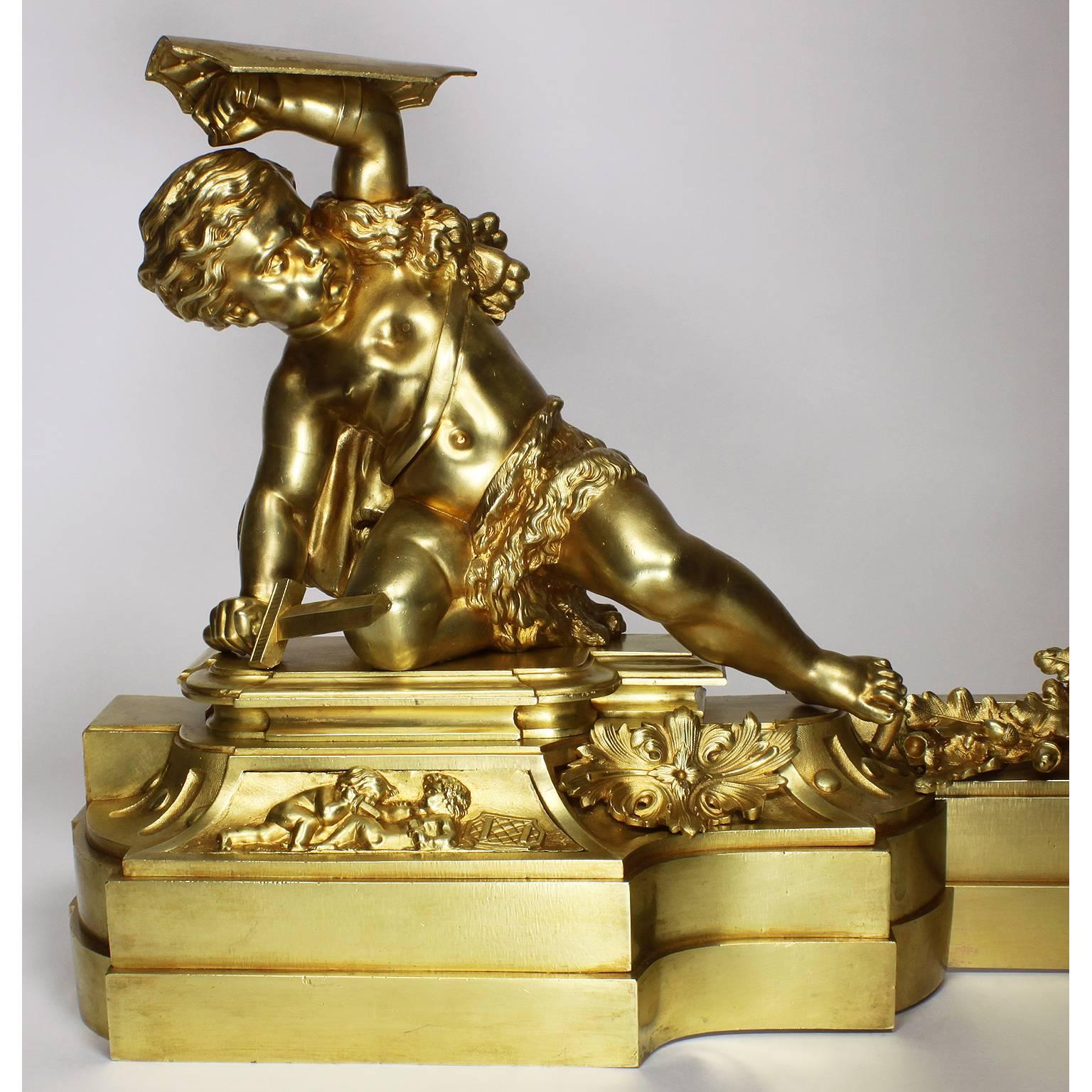 A fine and large French 19th century Louis XV style gilt bronze figural Chenet (andiron) and Fender Suite. The impressive fender surmounted on each end by a figure of playful battling armorial putto (children), one holding a sword and a shield, the