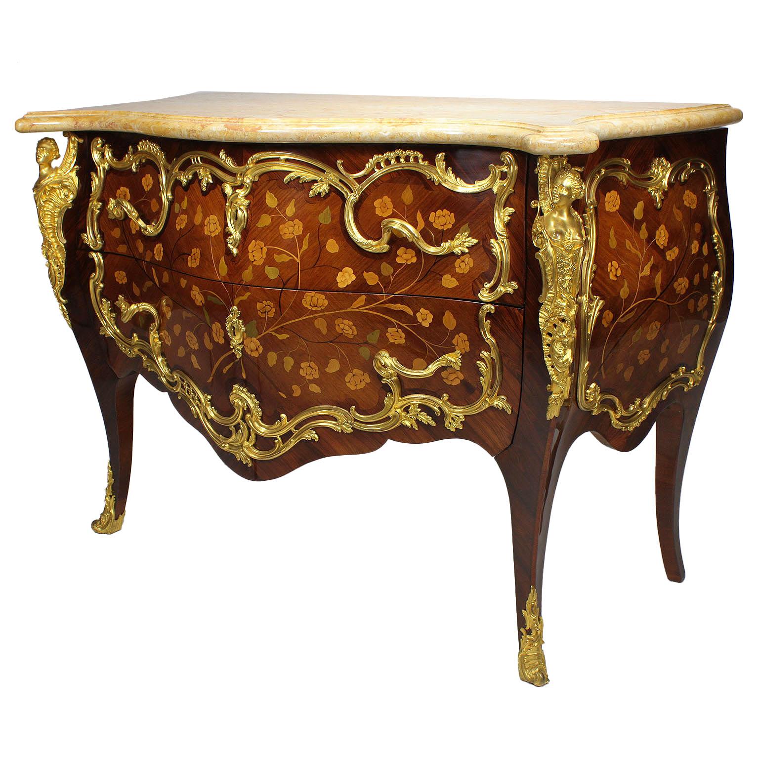 A very fine pair of French 19th century Louis XV style gilt bronze-mounted floral marquetry Bombé commodes with marble-top. The later serpentine Beige Perlato marble tops above a conforming case decorated with panels of scrolling flora and fauna and