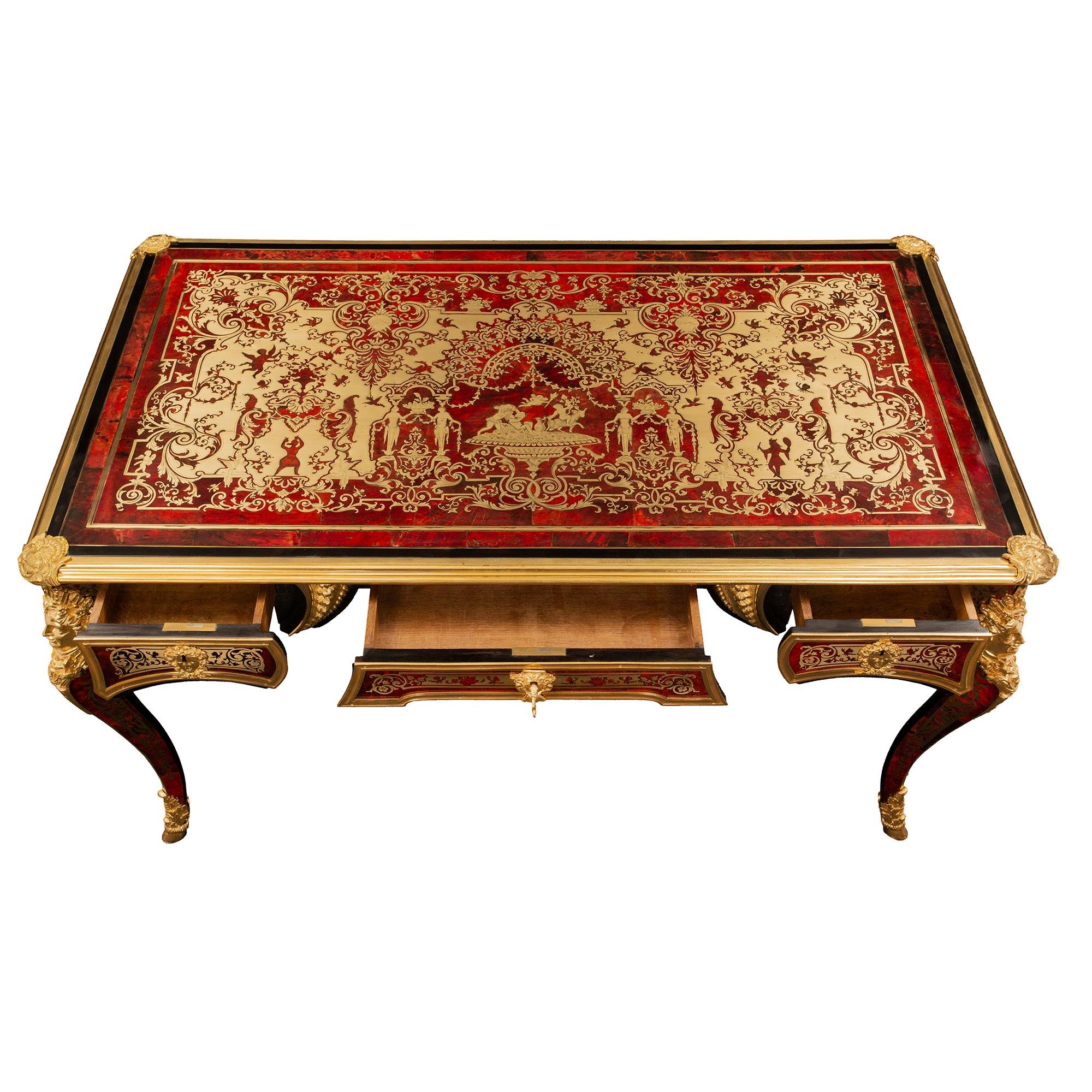 A spectacular French 19th century Louis XV style Napoleon III period brass inlaid, tortoise shell and ormolu Boulle Bureau Plat stamped Befort Jeune. The desk is raised by beautiful cabriole legs with stunning wrap around hoof feet ormolu sabots