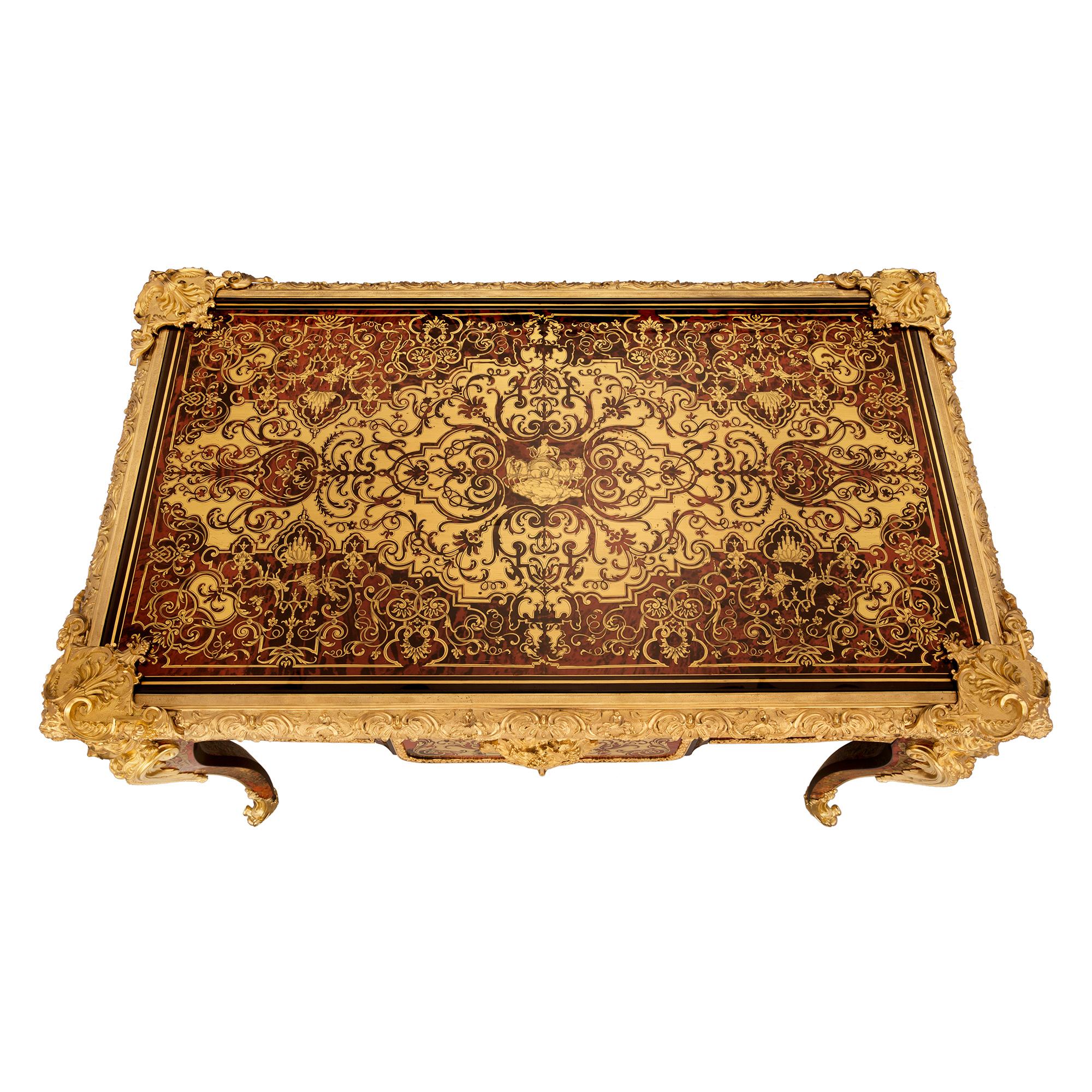 A stunning and extremely high-quality French 19th century Louis XV st. Napoleon III period tortoiseshell, ormolu, and brass inlaid desk signed Caillaux. The most impressive desk is raised by elegant cabriole legs with fine-fitted ormolu foliate