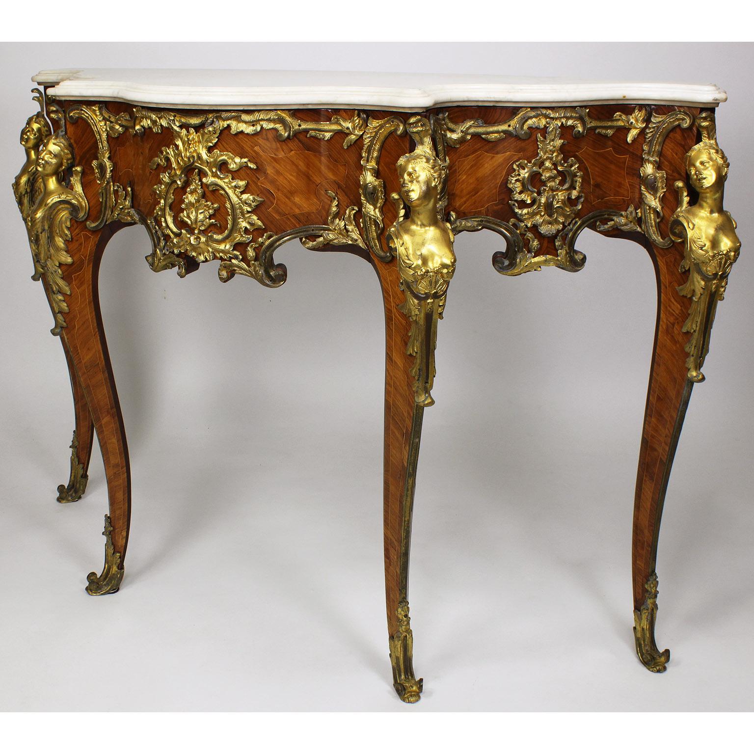 A very fine French 19th century Louis XV style Ormolu-Mounted tulipwood and mahogany console table with marble top, in the manner of Charles Cressent (French, 1685–1768). The serpentine white marble top above a wavy acanthus-mounted gilt-bronze