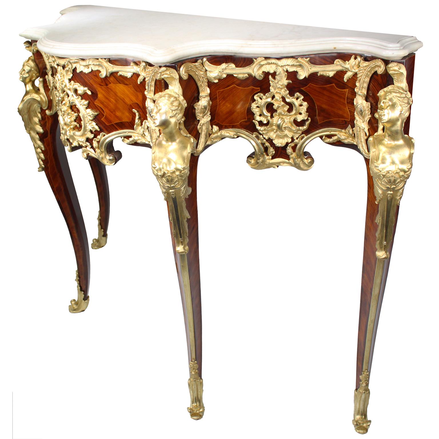 A very fine French 19th century Louis XV style Ormolu-Mounted tulipwood and mahogany console table with marble top, in the manner of Charles Cressent (French, 1685–1768). The serpentine white marble top above a wavy acanthus-mounted gilt-bronze