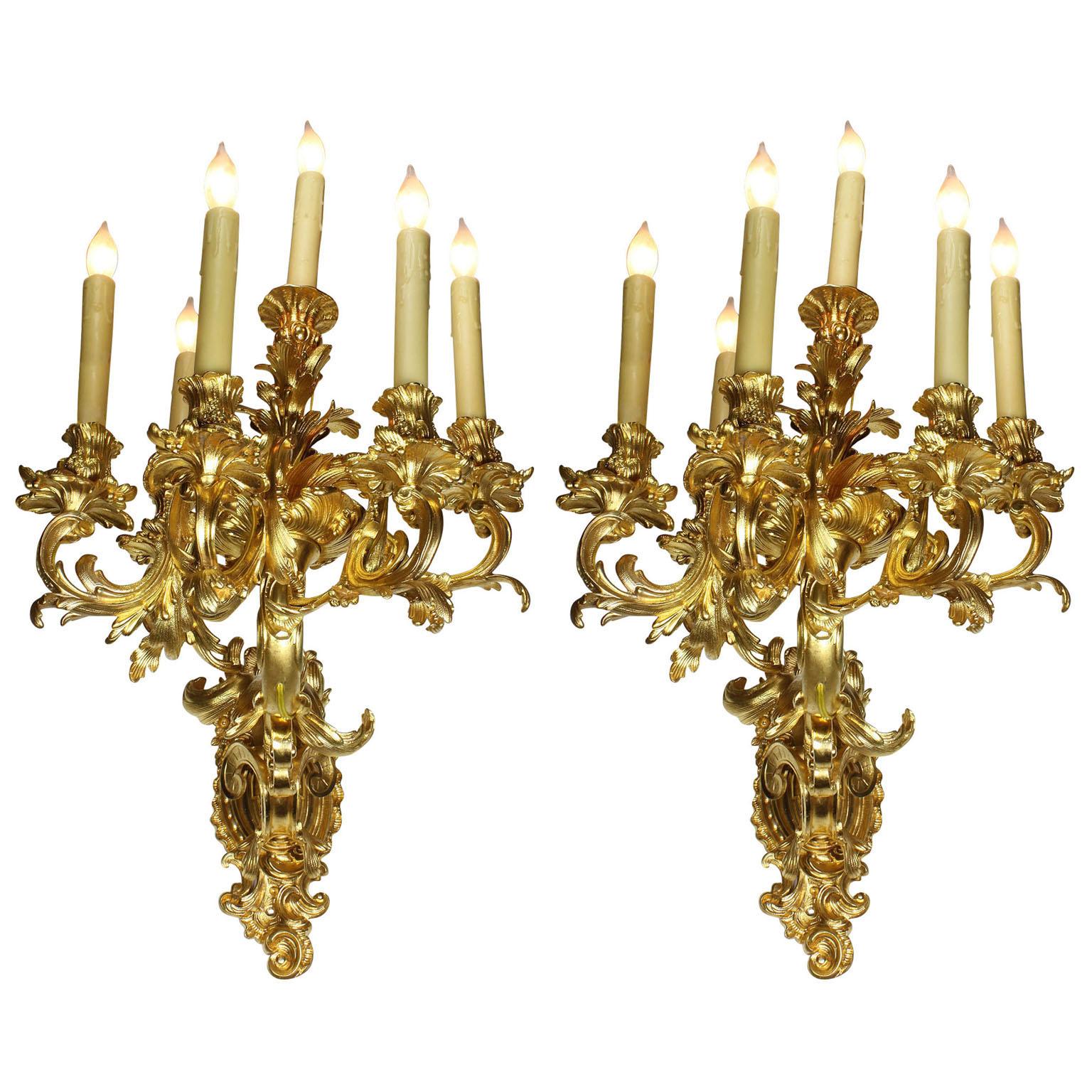 A very fine and impressive pair of French 19th century Louis XV style Rococo style six-light gilt-bronze wall lights - wall sconces. The ornate six-light candelabrum with five scrolled candle-arms with flowers, leaves and acanthus and centred with a