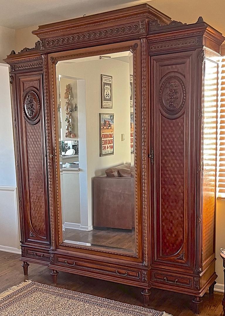 This is a very special piece of bedroom furniture. The armoire is from France and made in the Louis XV style in the 1950s. It has 2 doors open behind the full length mirror and a smaller one to the left. There are 3 drawers at the bottom of the