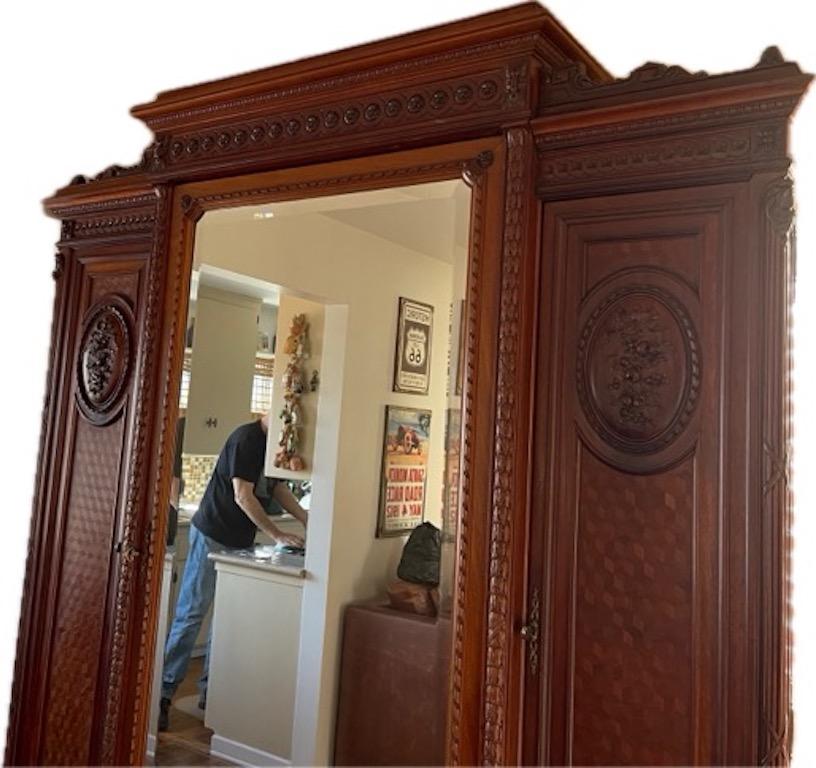 French 1950s Louis XV Style Stained Hand Carved Cherrywood Armoire In Distressed Condition In Santa Monica, CA