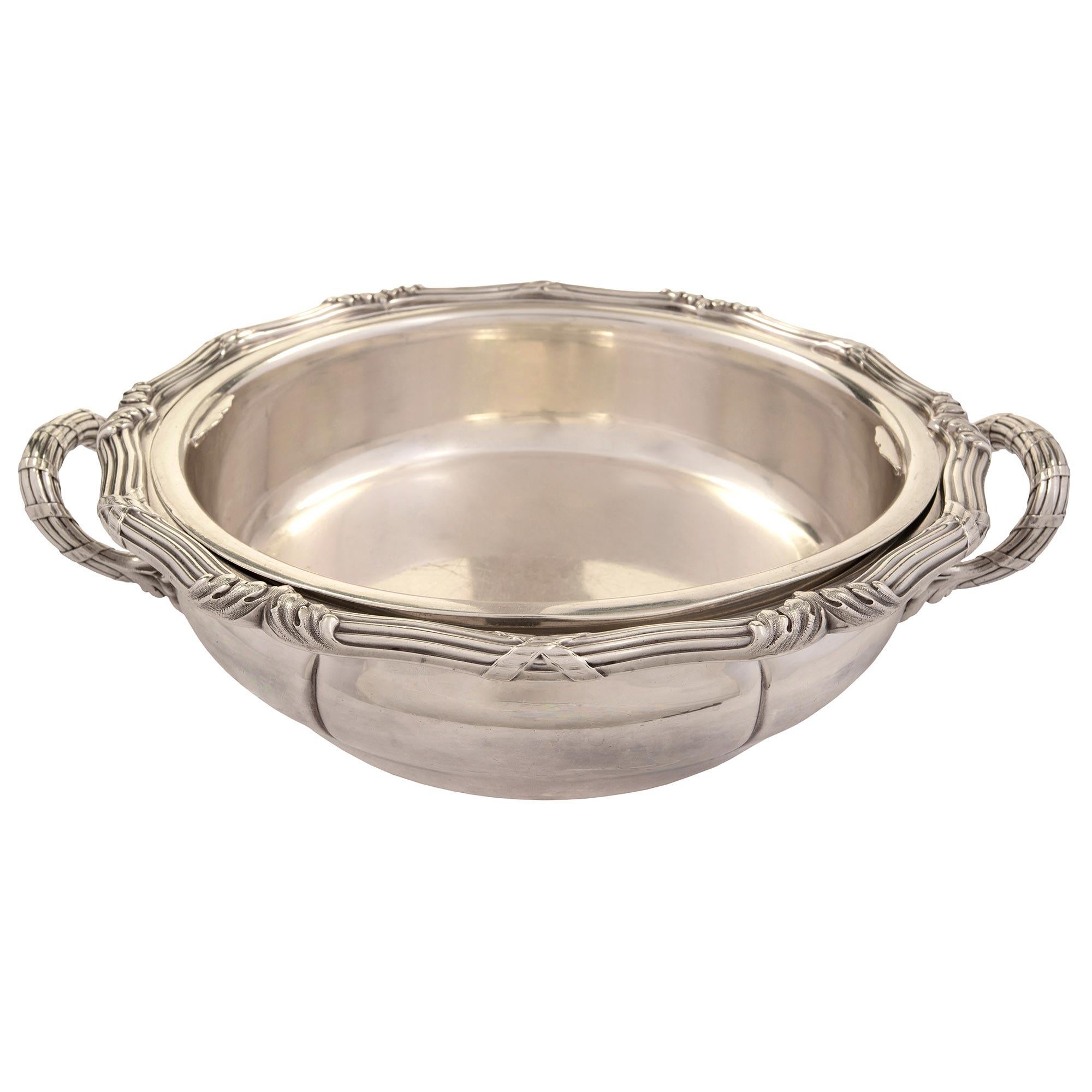 A fine French 19th century Louis XV st. Sterling silver tureen from Maison Odiot, stamped PR - Maison ODIOT PRÉVOST & Cie. 1449 with its original fitted insert. The tureen displays a most charming and decorative shape with tied reeded handles at