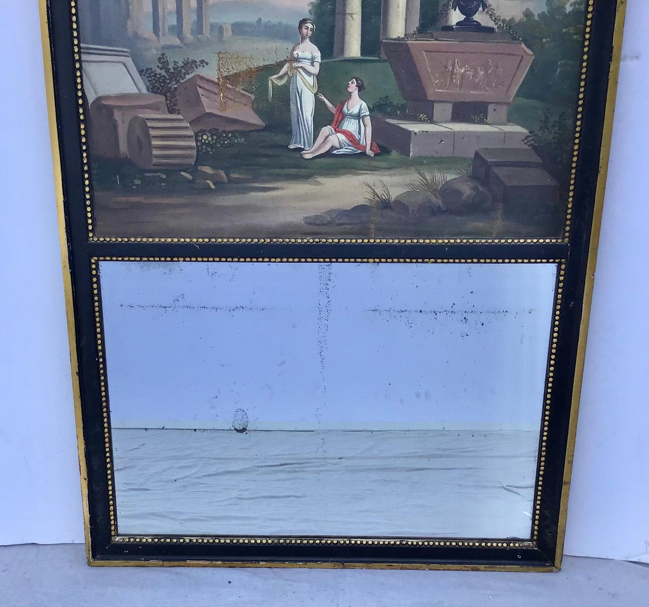 An early 19th century French Louis XV style trumeau mirror. Fine oil painting depicting two maidens in a garden setting with a ruins in the background. Giltwood frame with beaded border trim. Original mirror with old silvering. Wonderful old world