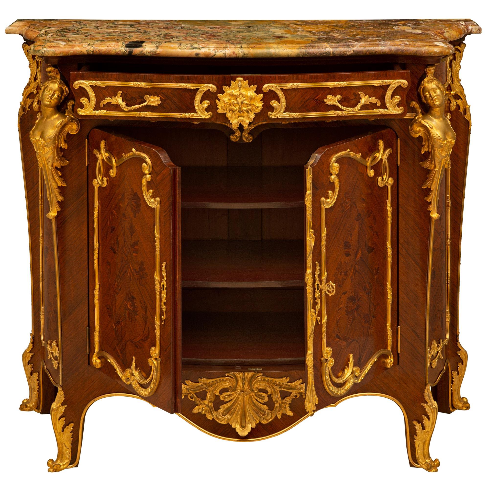 A sensational French 19th century Louis XV style tulipwood, kingwood and ormolu cabinet, attributed to Zweiner. The cabinet is raised by handsome scrolled legs with with rich acanthus leaf sabots and a fine ormolu chute which extends up to most
