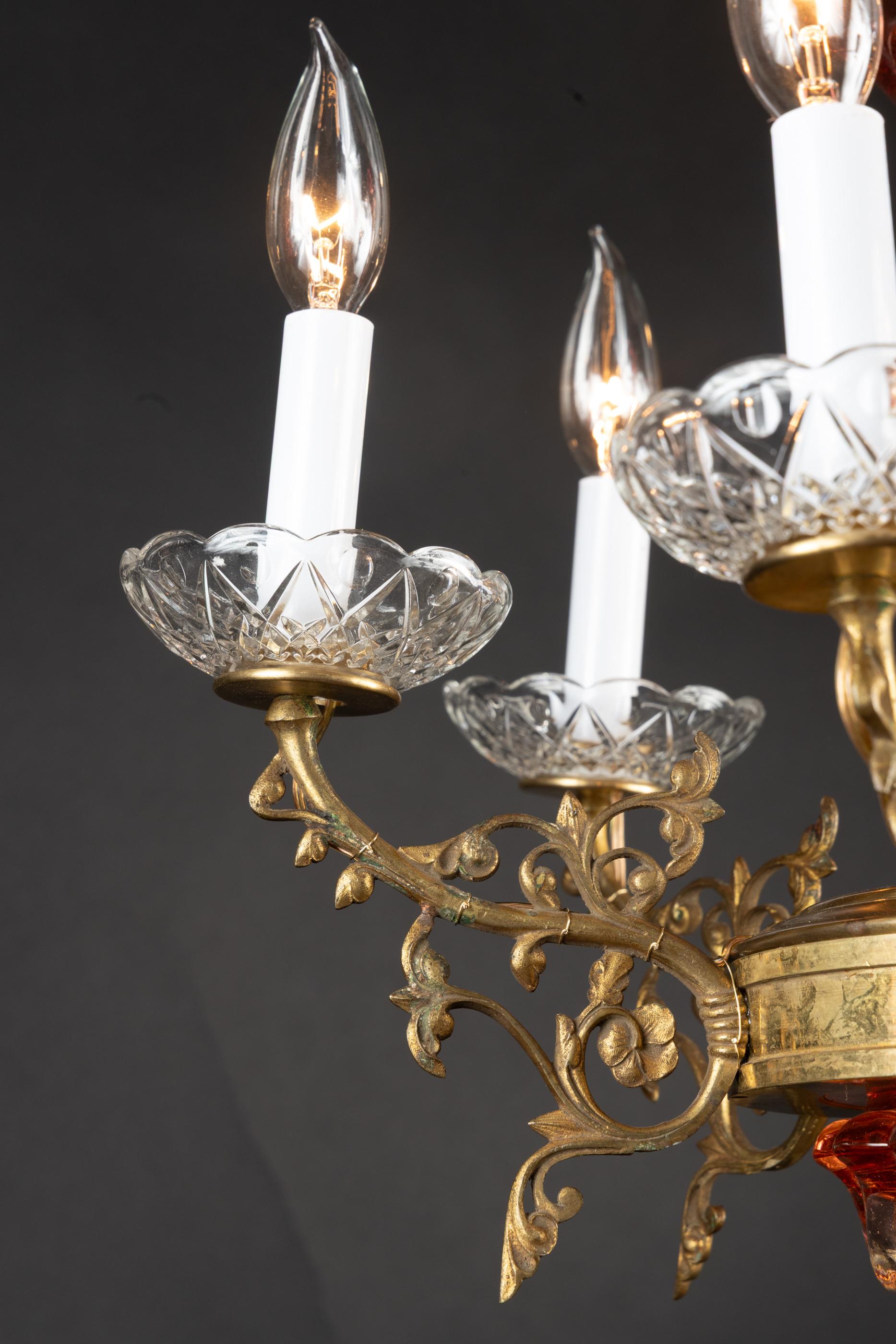 This beautiful French 19th century chandelier is made of bronze d’ore and features fantastic Baccarat crystal. The piece plays host to six detailed arms with fine baccarat crystal bobeches. The center is made of magnificent baccarat crystal, which
