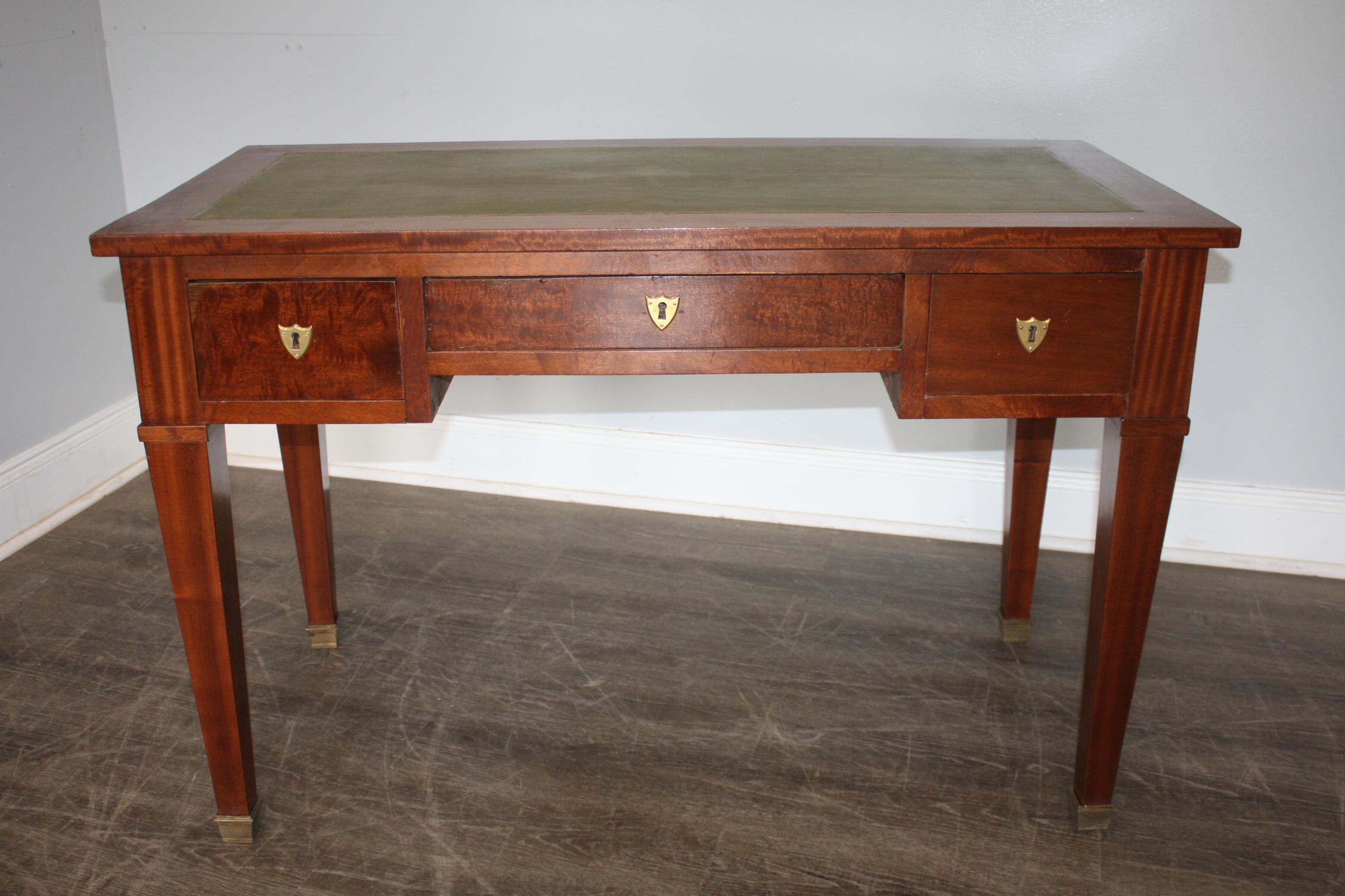 This desk is made of flamed mahogany and a green leather top, it is a Louis XVI style.