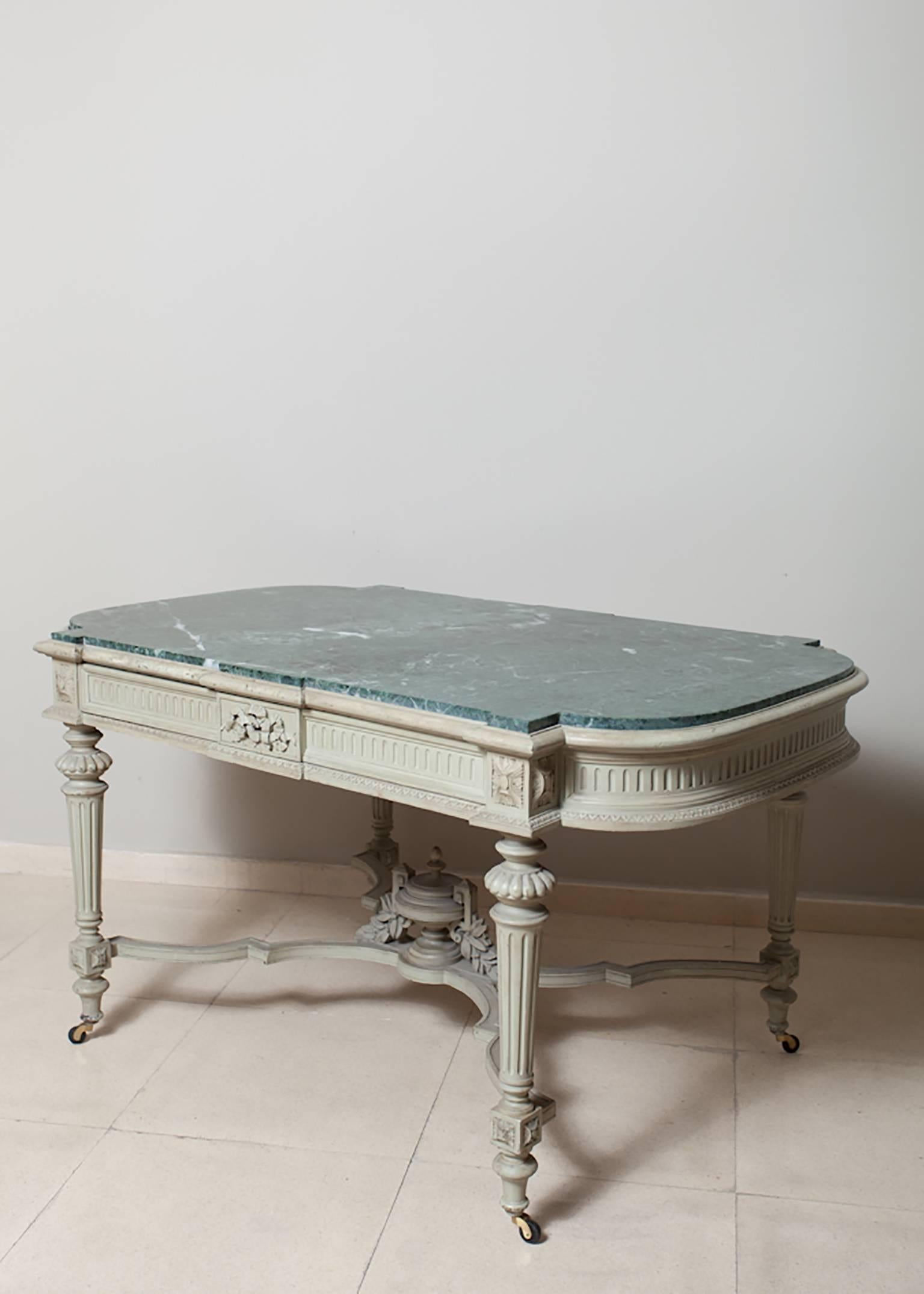 Louis XVI style centre table or desk. Painted in green-grey with marble top half inset, in green color too and a single large drawer. Detailing hand carved details.