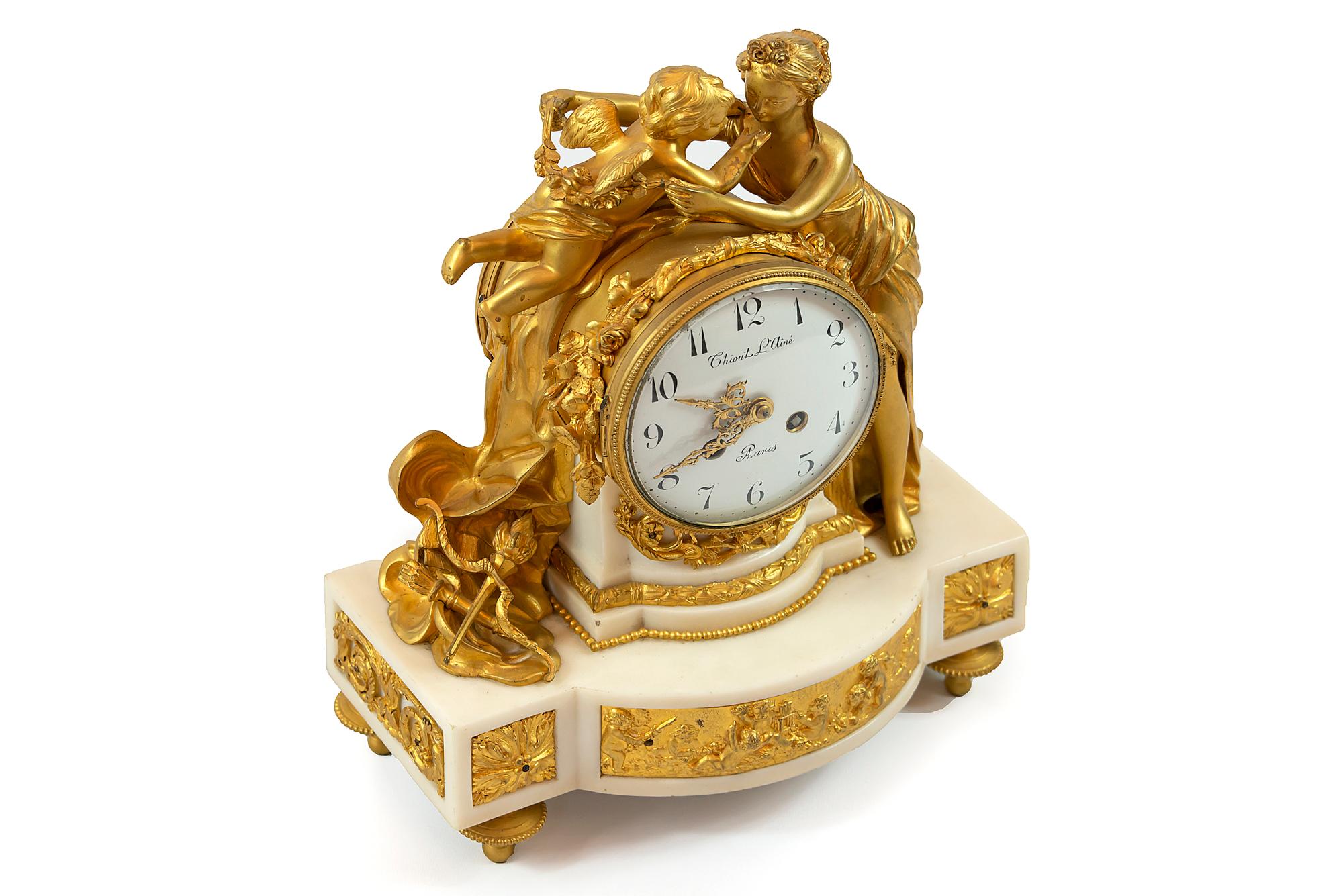 Antique 19th century French gilded bronze and white marble mantel clock of the period Louis XVI.
  