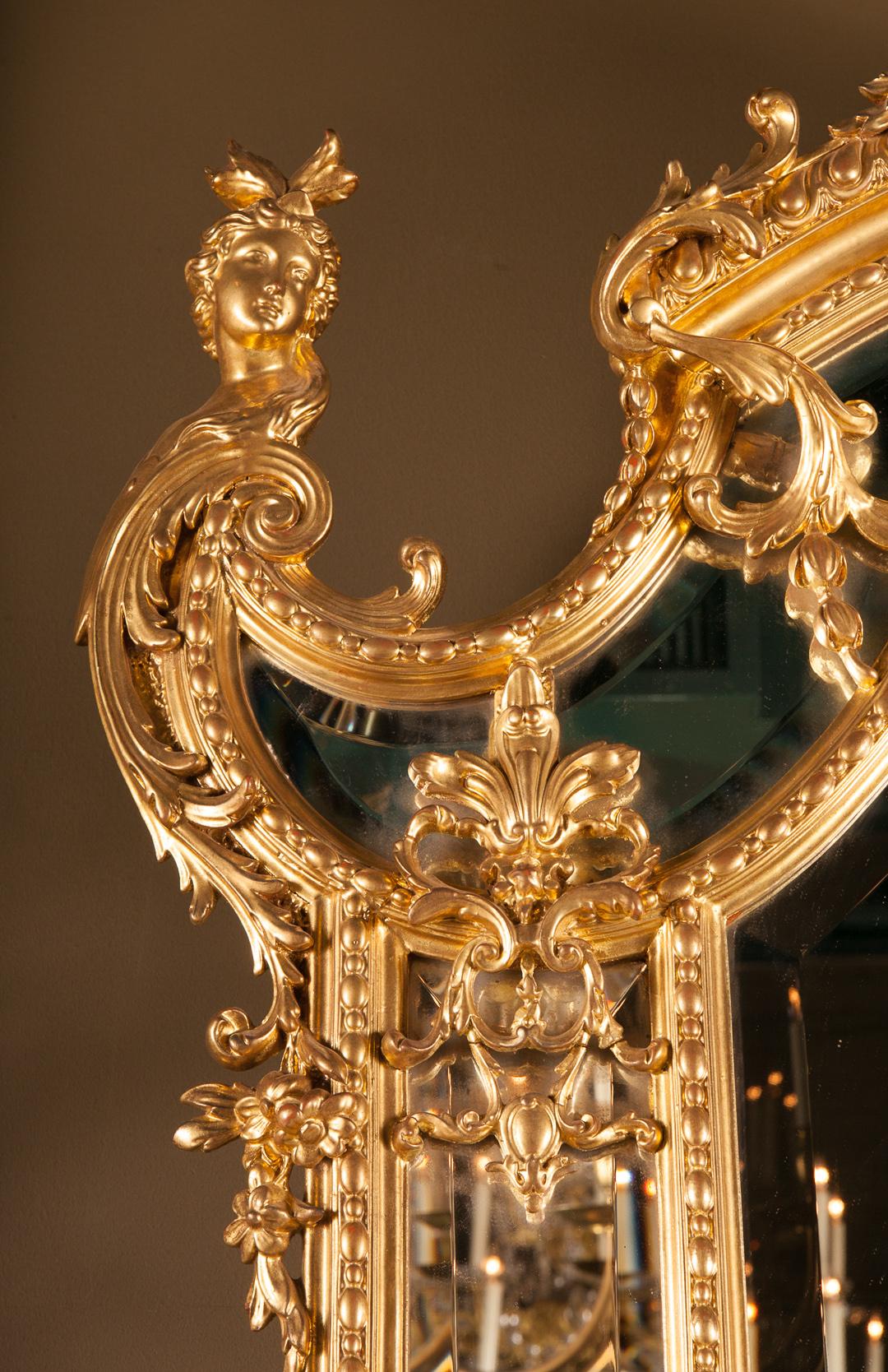 French 19th century Louis XVI carved and gold leaf mirror adorned with herm on either side. The mirror features beautifully carved details overlapping the sectioned bevelled glass.

This piece is a collection of a fourth generation, family owned