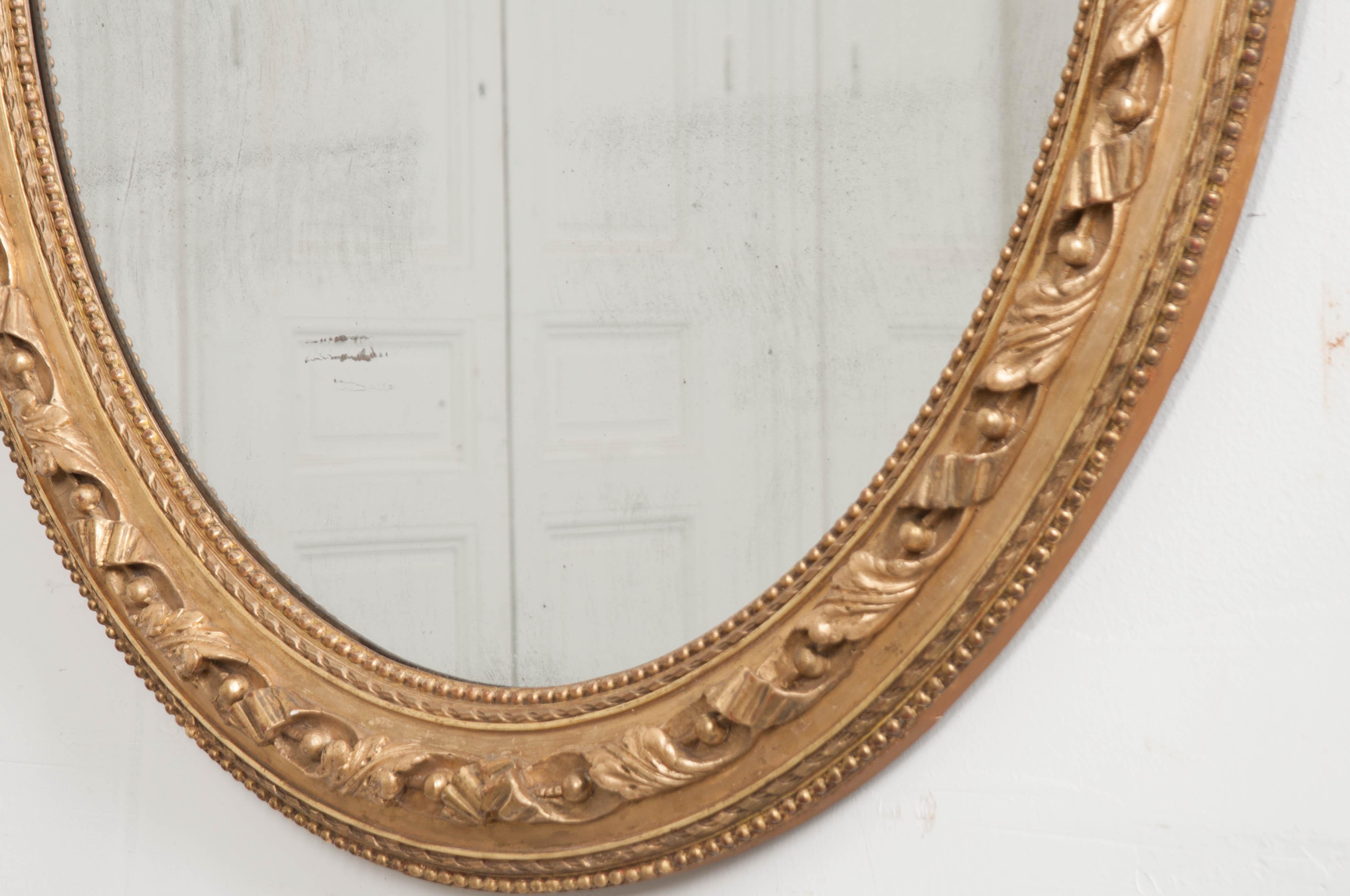 Carved French 19th Century Louis XVI Oval Giltwood Mirror For Sale