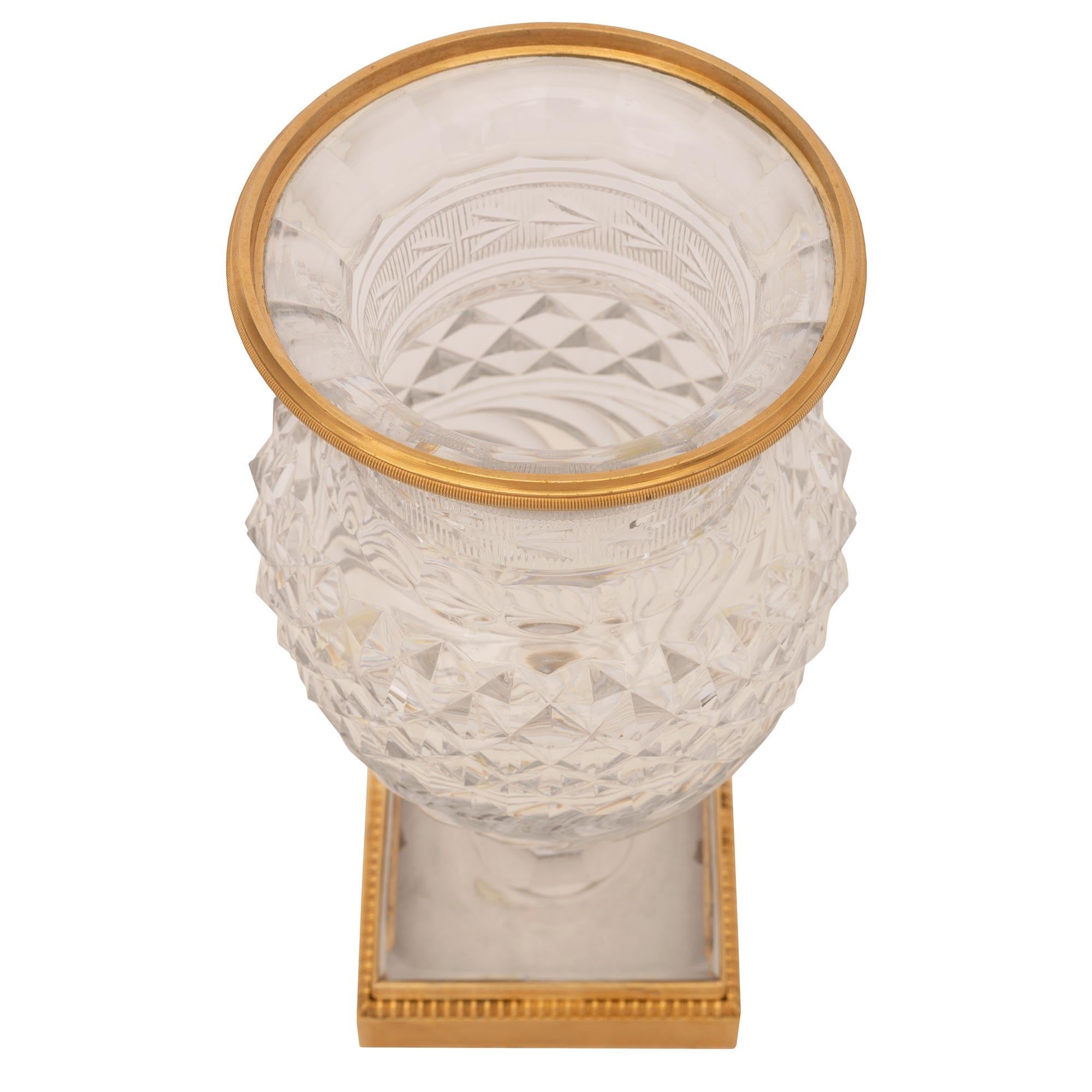 An exceptional and most elegant French 19th century Louis XVI st. Belle Époque period Baccarat crystal and ormolu potpourri vase. The vase is raised by a fine square ormolu base with a textured design framed within a delicate fillet and a lovely