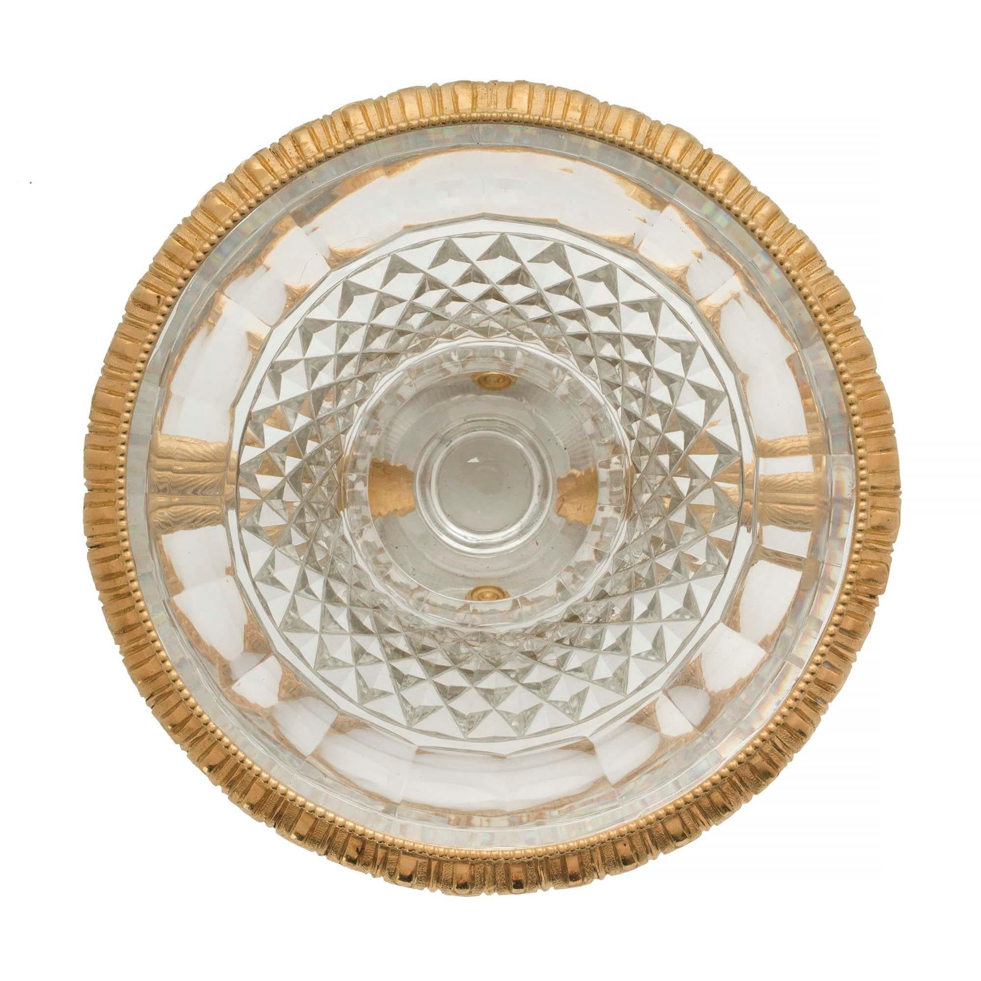 A striking French 19th century Louis XVI st. Baccarat crystal and ormolu vase. The vase is raised by a square base with a fine coeur de rai pattern. Above the Baccarat crystal fluted socle pedestal is the beautifully etched elegantly shaped body