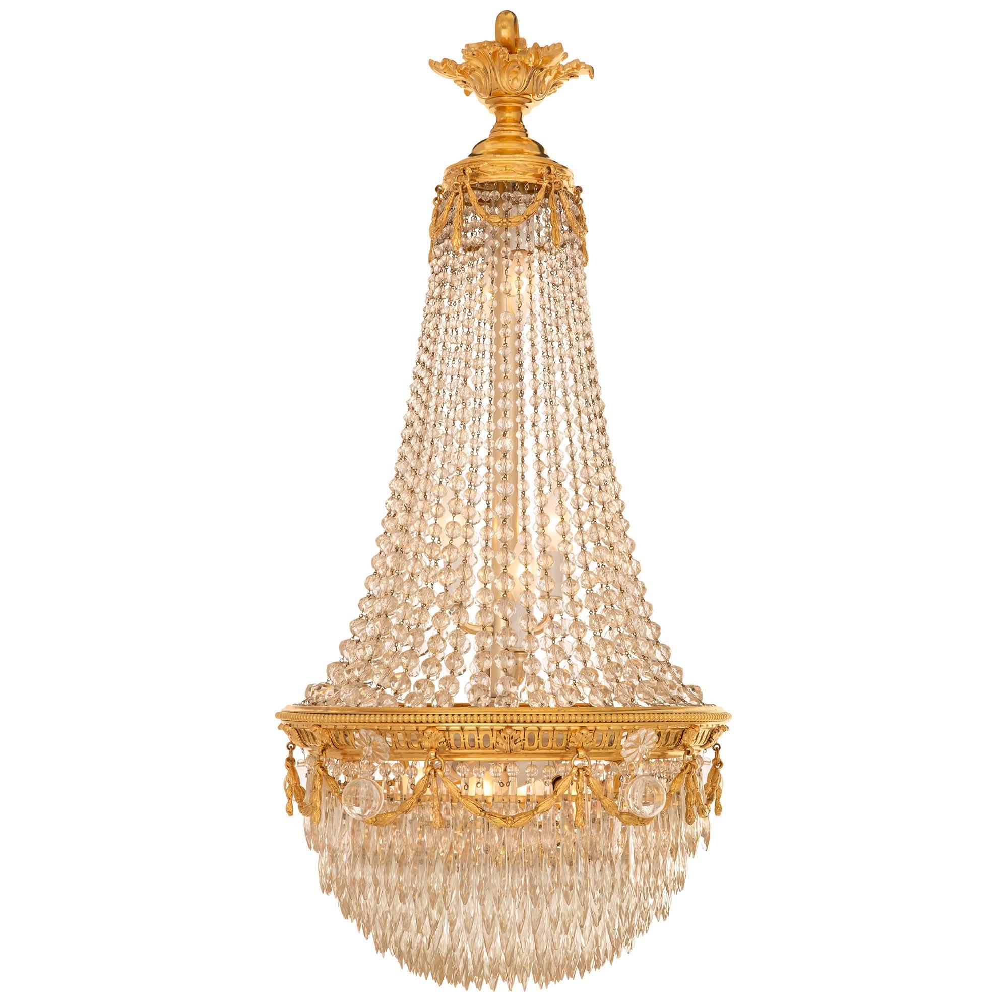 A beautiful and most elegant French 19th century Louis XVI st. Baccarat crystal, cut glass, and ormolu chandelier. The eleven bulb chandelier displays a graceful montgolfière shape with a most decorative dome shaped array of prism shaped cut crystal