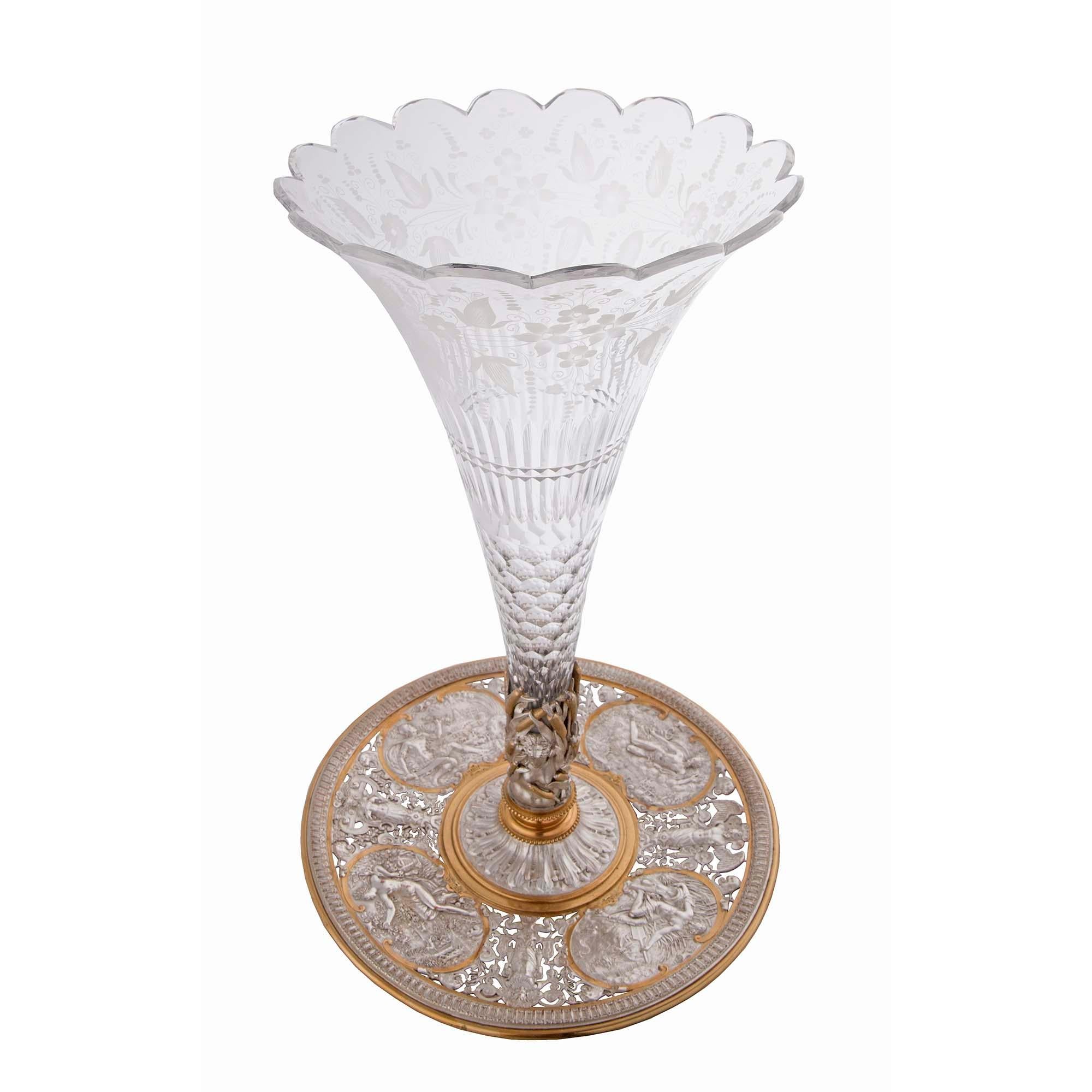 A charming French 19th century Louis XVI st. Baccarat crystal vase. The vase is raised by four fine foliate feet below the circular ormolu and silvered bronze tray. The tray is decorated with a lovely egg and dart border and has four richly chased