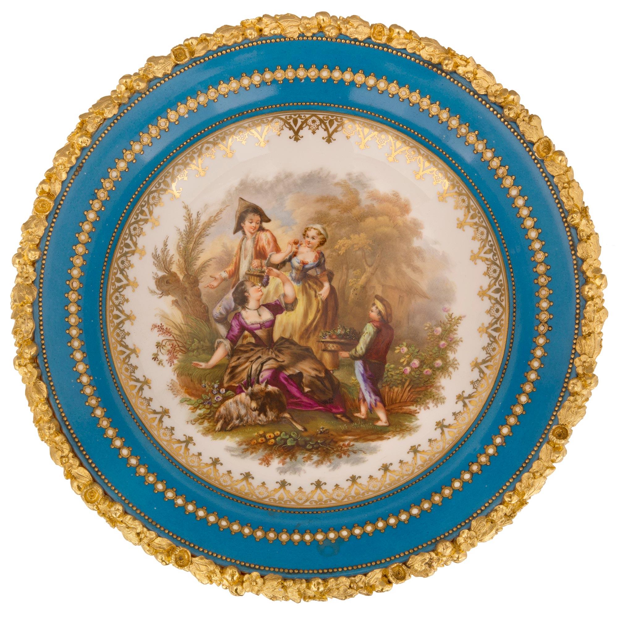 A beautiful and high quality French 19th century Louis XVI st. Belle Époque period ormolu and Sèvres porcelain centerpiece. The centerpiece is raised by a most decorative ormolu scrolled foliate base with charming richly chased grape leaves, grape