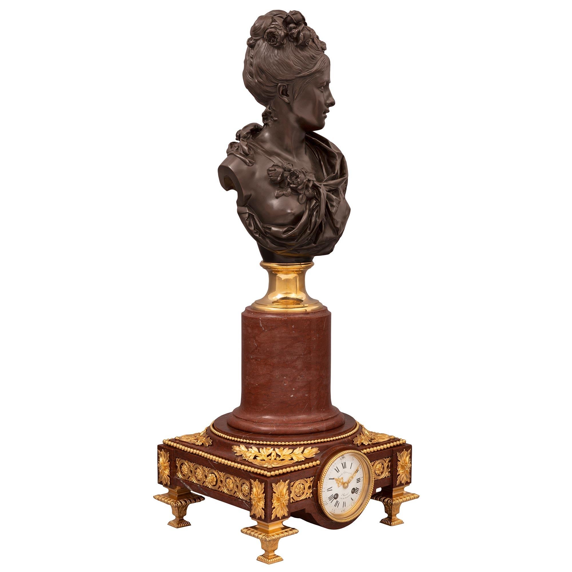An impressive and high quality French 19th century Louis XVI st. Belle Époque period Rouge Griotte marble, ormolu and patinated bronze clock and bust by Emile Colin & Cie and A. Carrier. The clock is raised by unique and extremely decorative curved