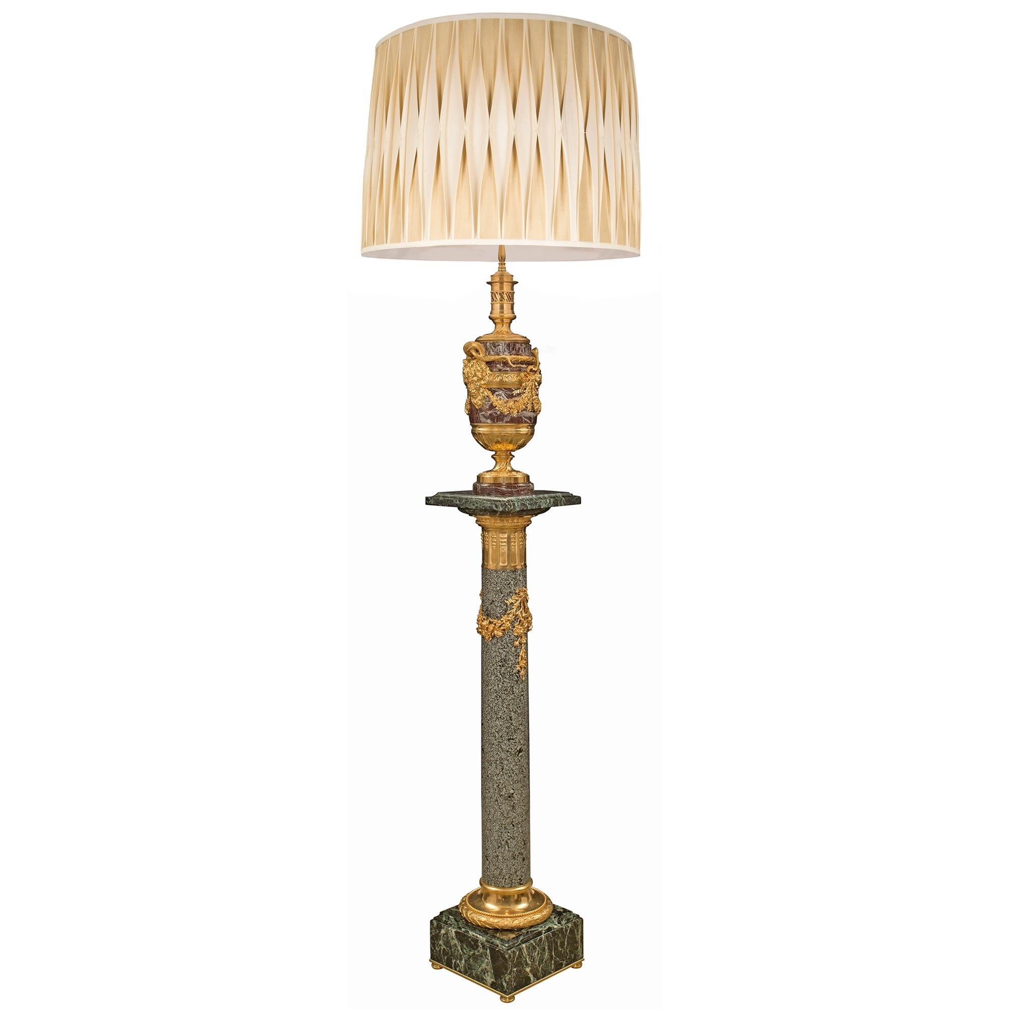 A stunning French 19th century Louis XVI st. Belle Époque period Rosso Levanto and Vert de Patricia marble, granite and ormolu floor lamp, attributed to Henry Dasson. The floor lamp was once an oil lamp, is raised by a square Vert de Patricia base