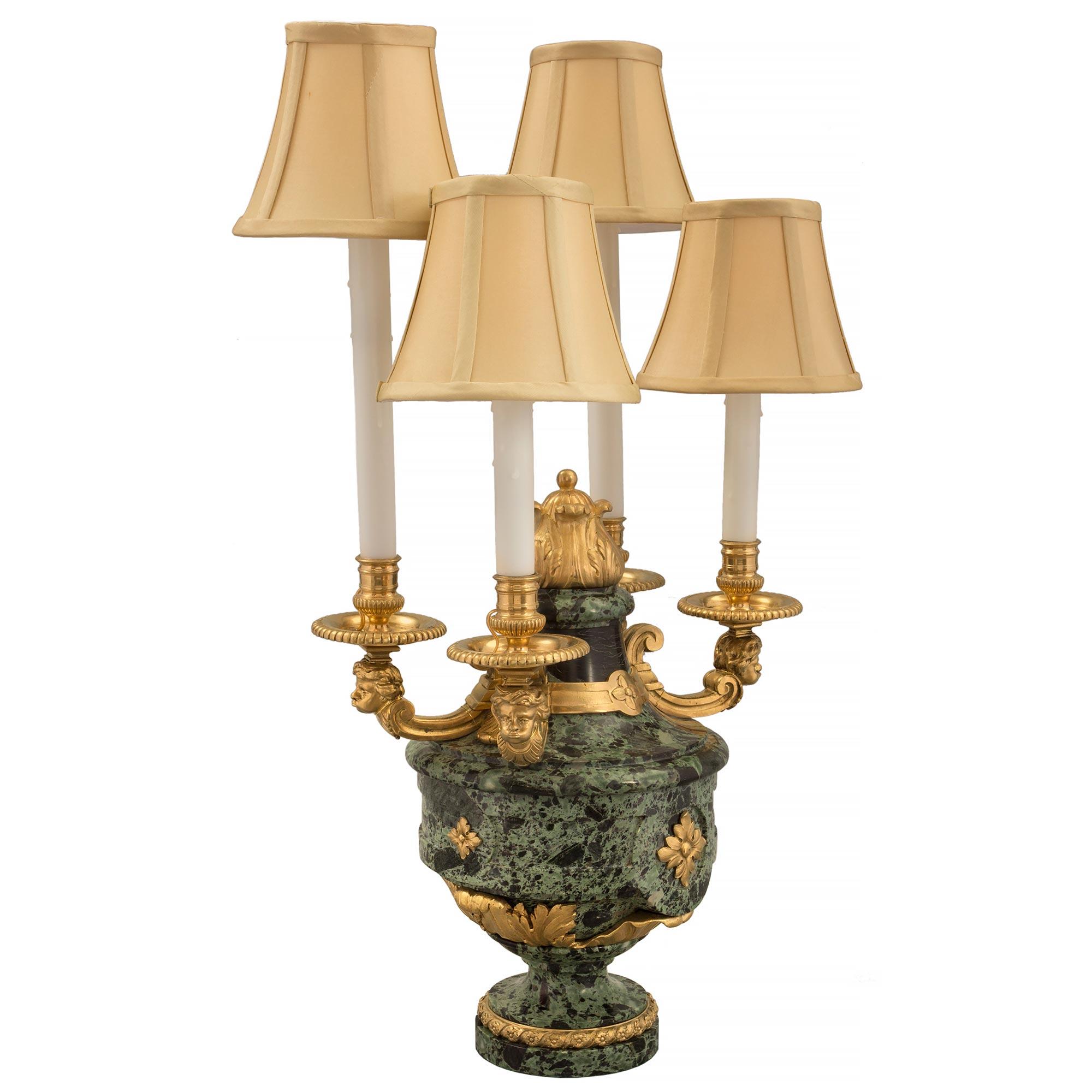 A sensational and high quality pair of French 19th century Louis XVI st. Belle Époque period Vert Antique marble and ormolu four arm candelabra lamps, attributed to Henry Dasson. Each lamp is raised by a circular base with an elegant wrap around