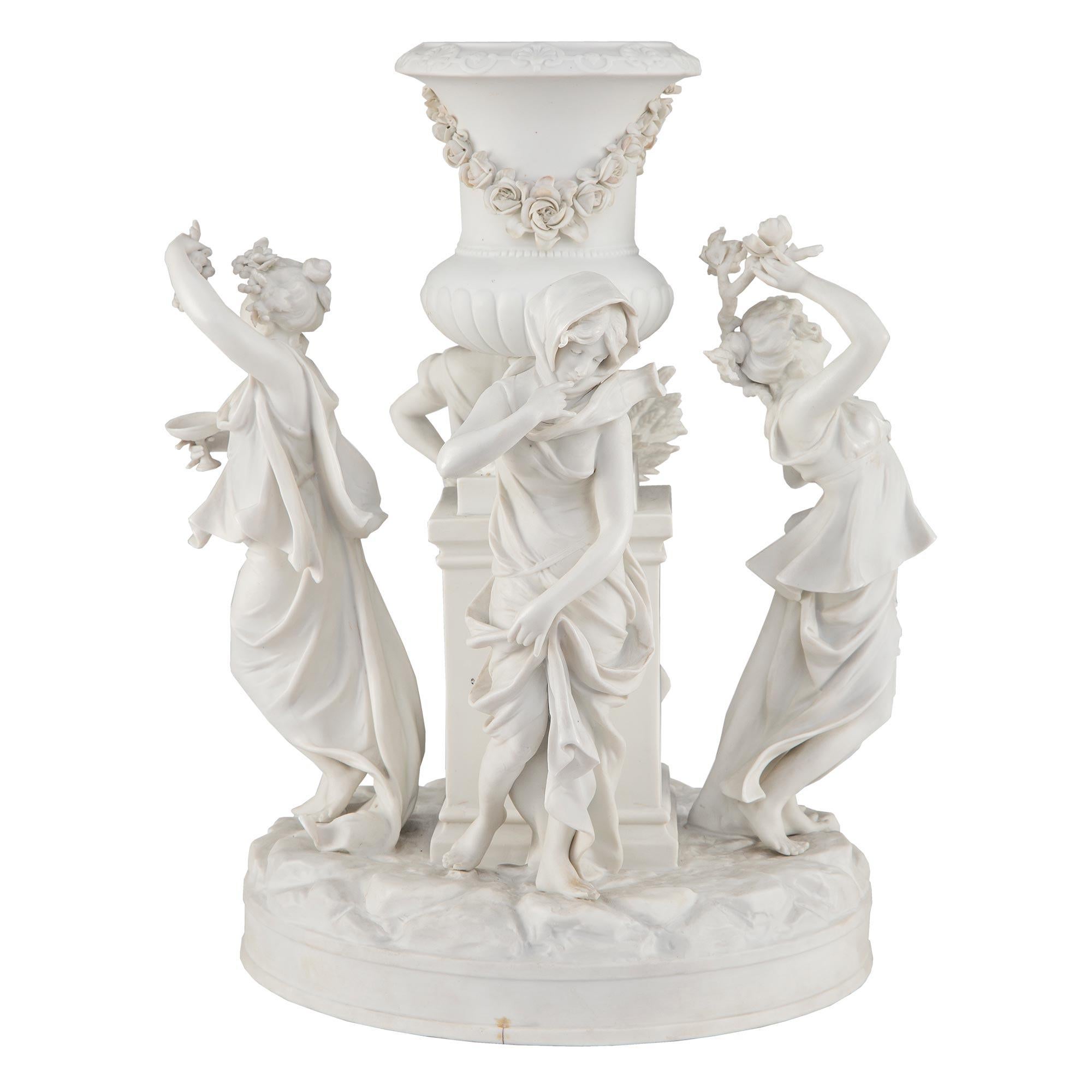 A stunning and wonderfully executed French 19th century Louis XVI st. Biscuit de Sèvres porcelain centerpiece. The most elegant centerpiece is raised by a circular base with a ground-like design where four stunning maidens depicting the four seasons