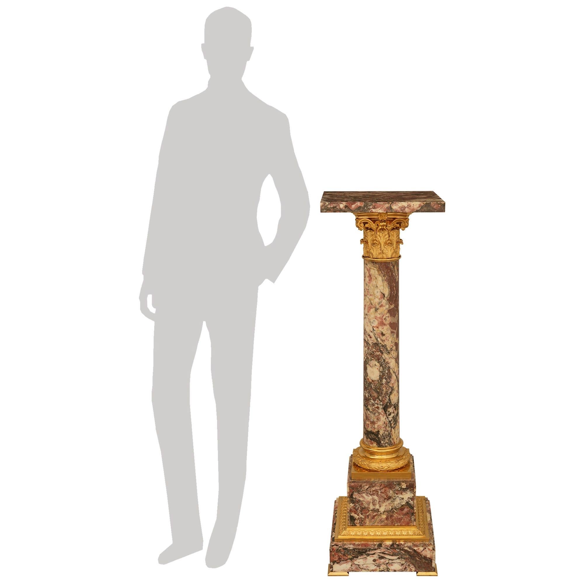 A most impressive and high quality French 19th century Louis XVI st. Breche Violette Marble and Ormolu pedestal. This stunning pedestal is raised by four Ormolu corner supports below the square marble base. Above is a secondary square base separated
