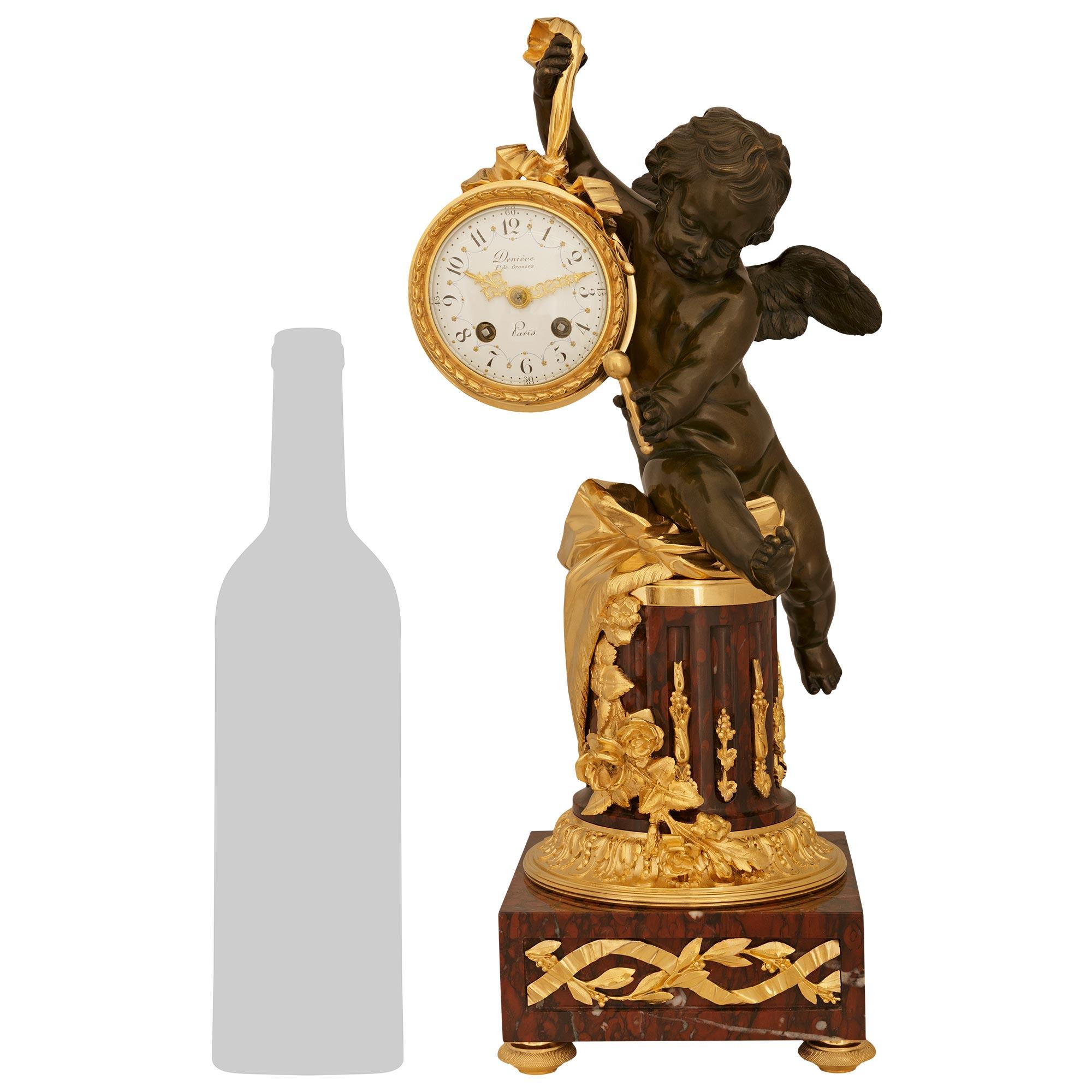 A superb and high quality French 19th century Louis XVI st. patinated Bronze, Ormolu and Rouge Griotte marble clock, by Jean Francois Denière. This stunning clock is raised by four Ormolu topie shaped feet supporting a square block of Rouge Griotte
