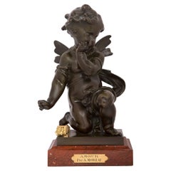 Statue en bronze, bronze doré et marbre intitulée Amour.